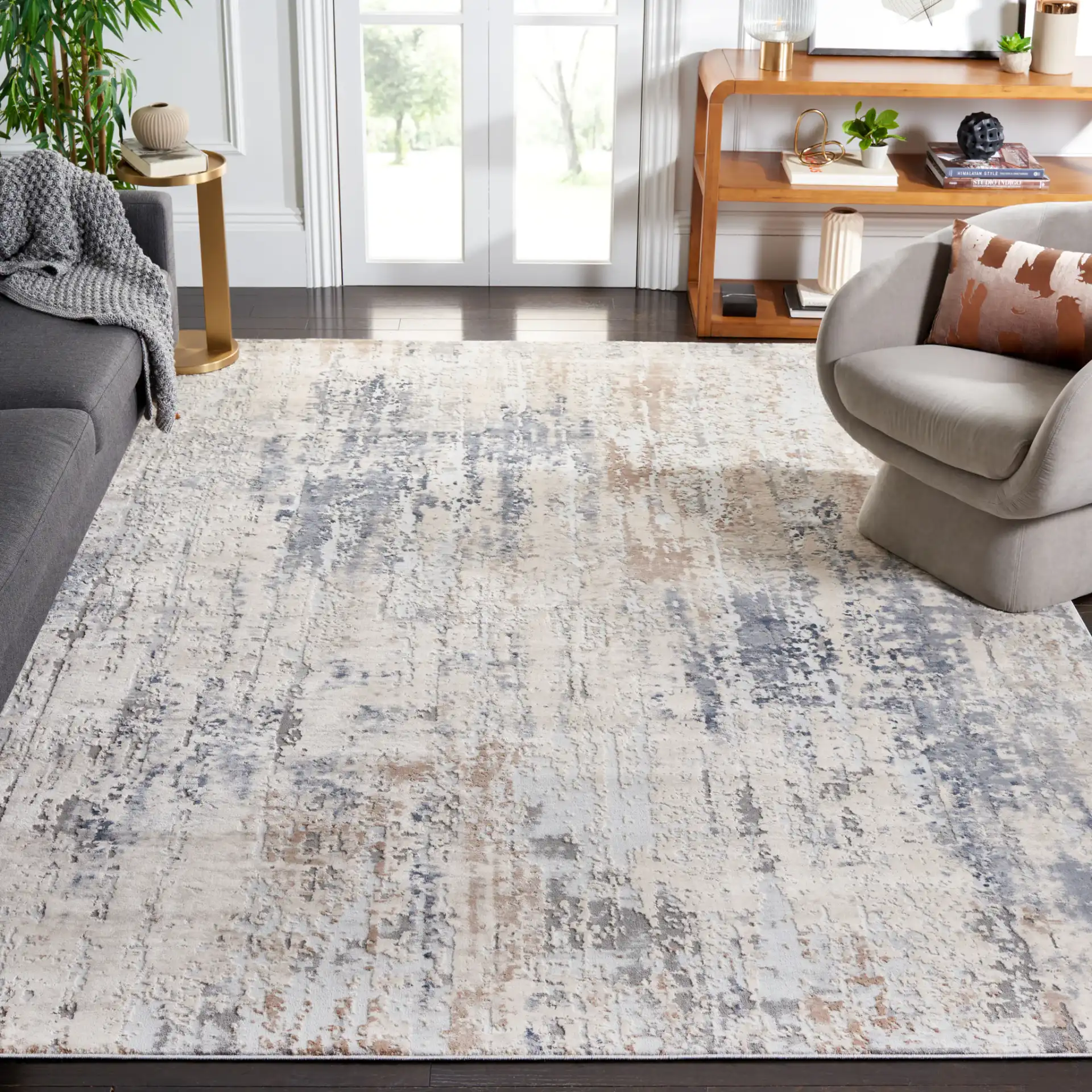 Reflection Distressed Abstract Rug in Cream / Gray in a styled room