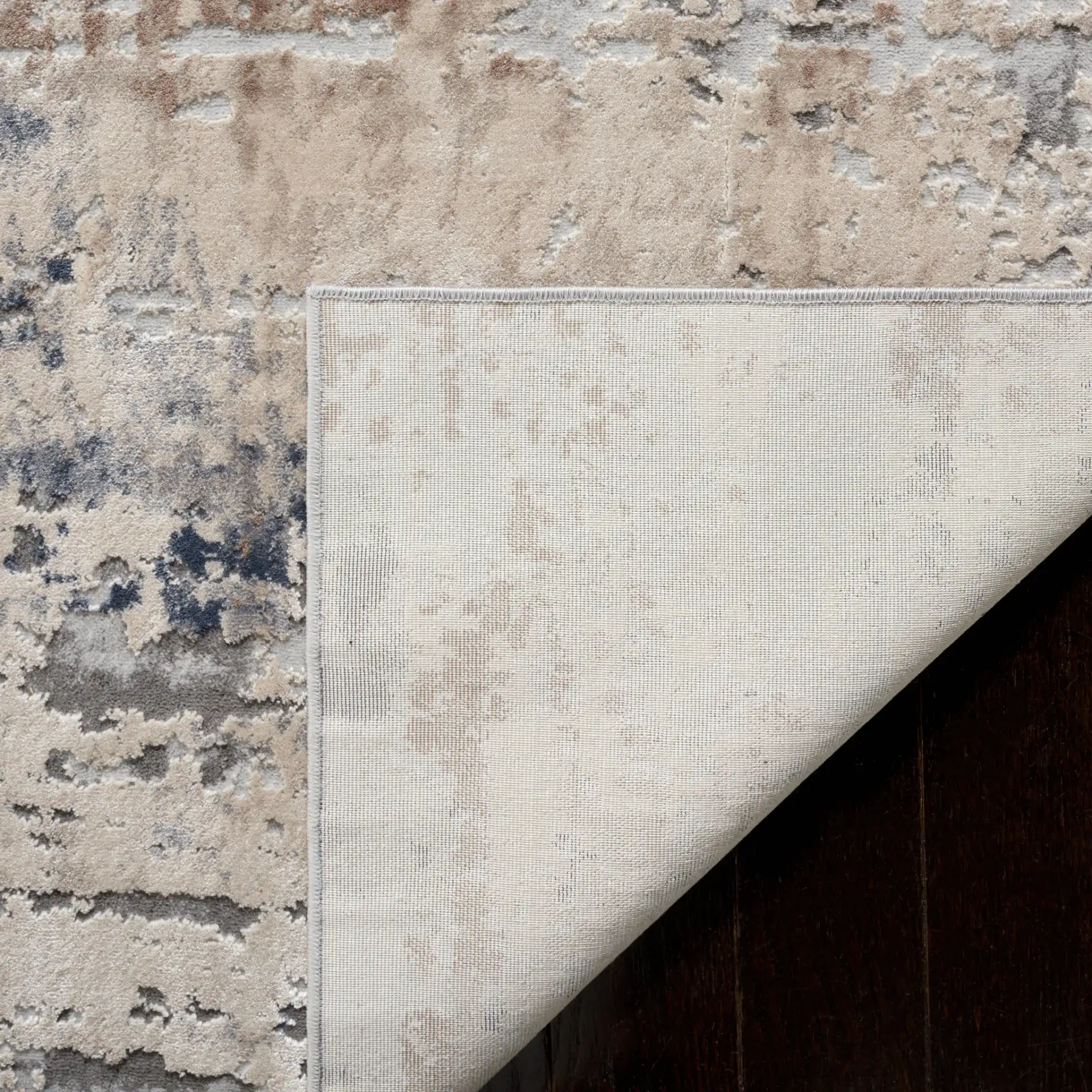 Reflection Distressed Abstract Rug in Cream / Gray in a styled room