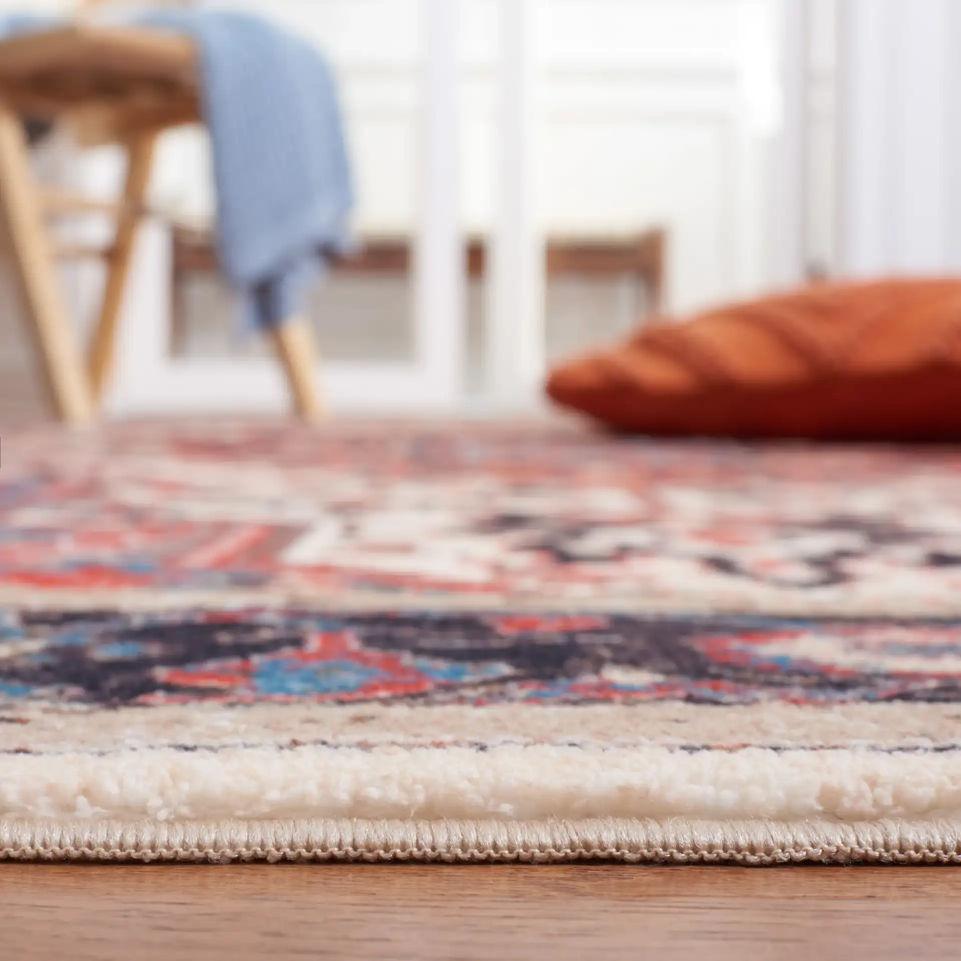Riviera Medallion Bordered Washable Rug in Ivory / Blue in a styled room