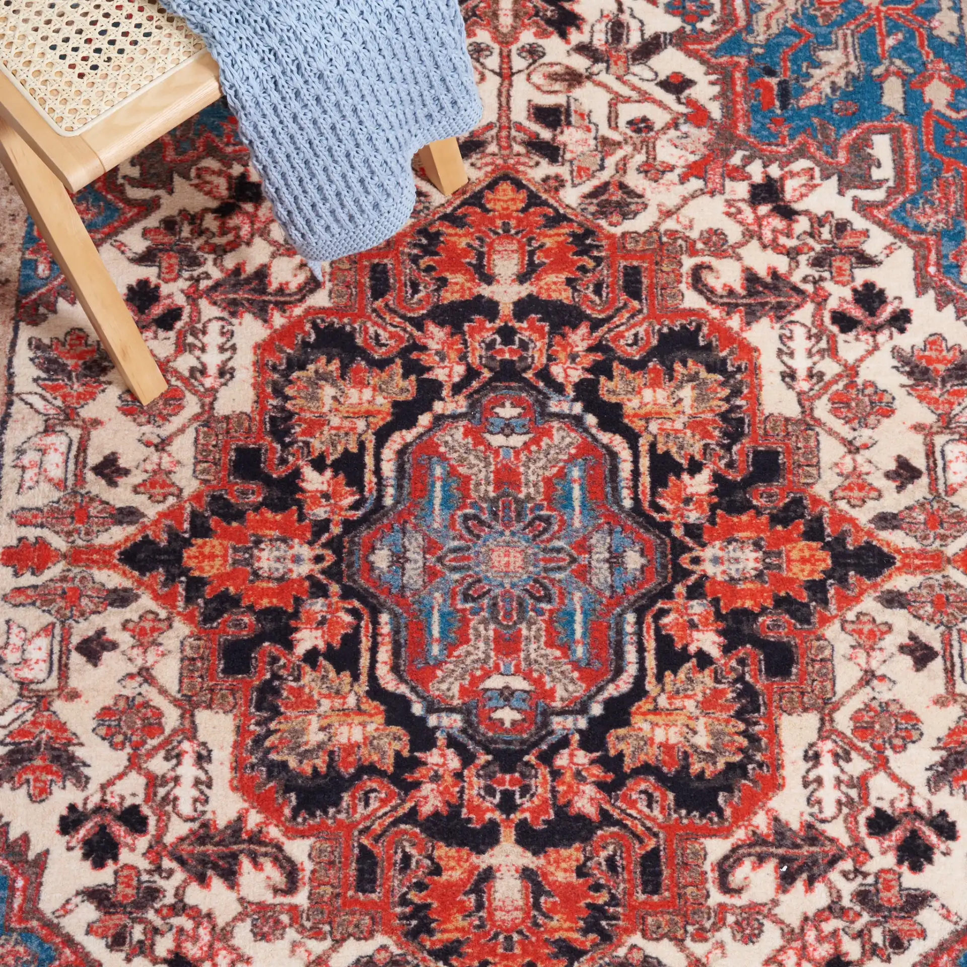 Riviera Medallion Bordered Washable Rug in Ivory / Blue in a styled room