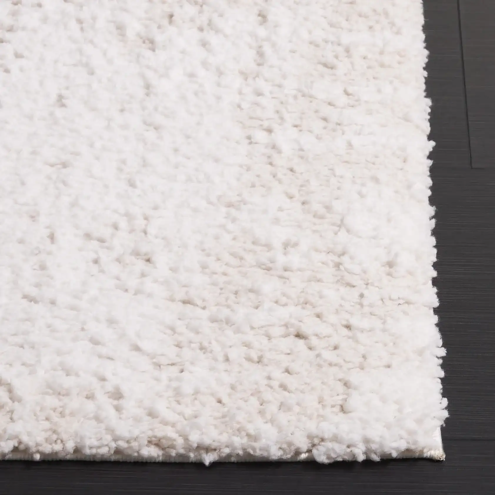 Rumi Textured Heathered Shag Rug in Ivory / Light Beige in a styled room