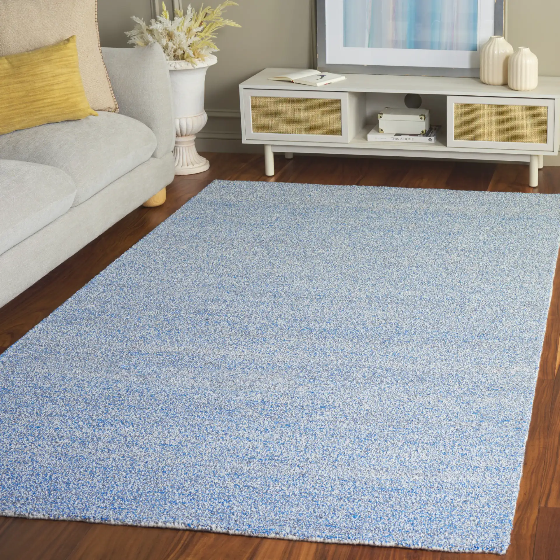 Renewal Heathered Solid Hand-Tufted Rug in Blue / Ivory in a styled room