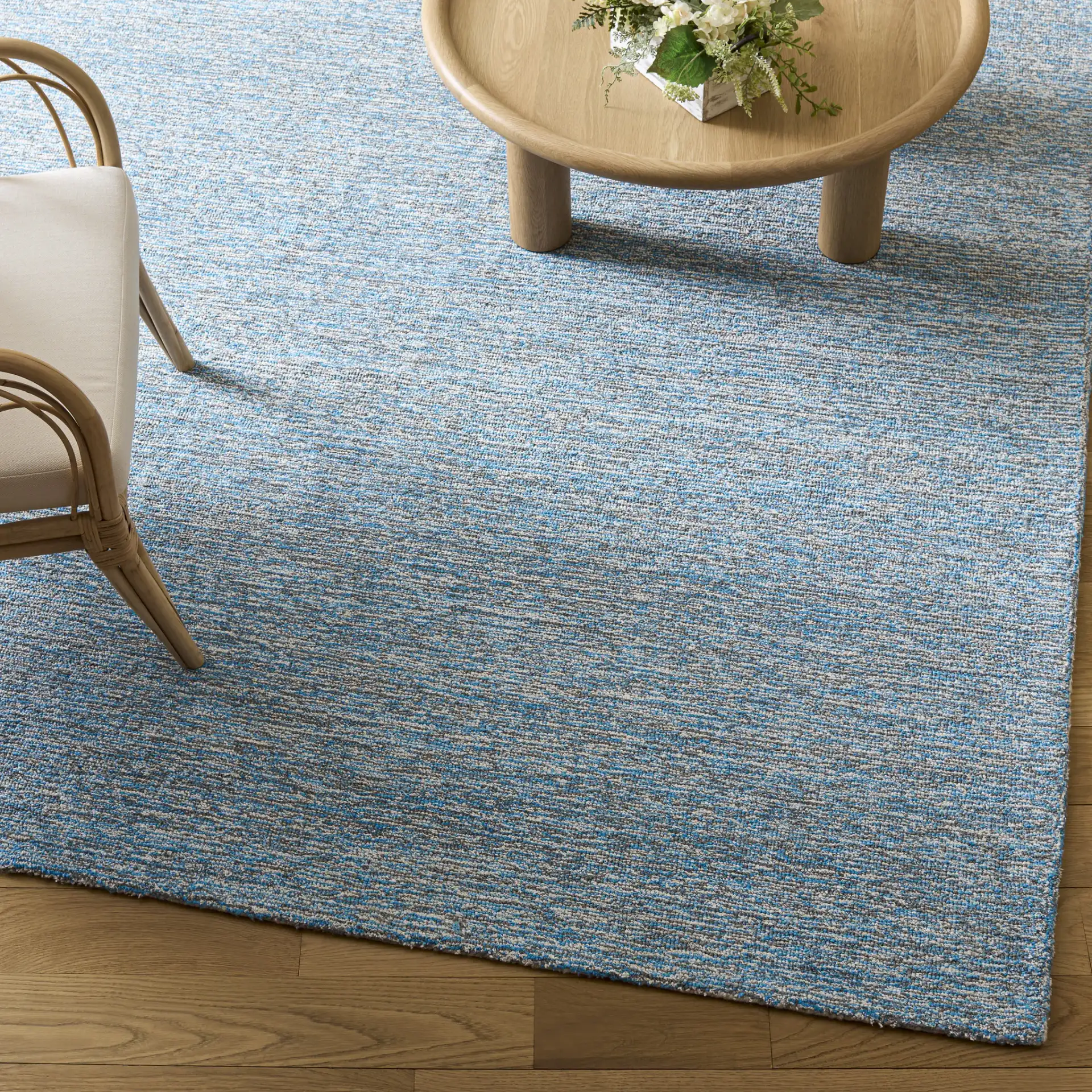 Renewal Heathered Solid Hand-Tufted Rug in Blue / Ivory in a styled room
