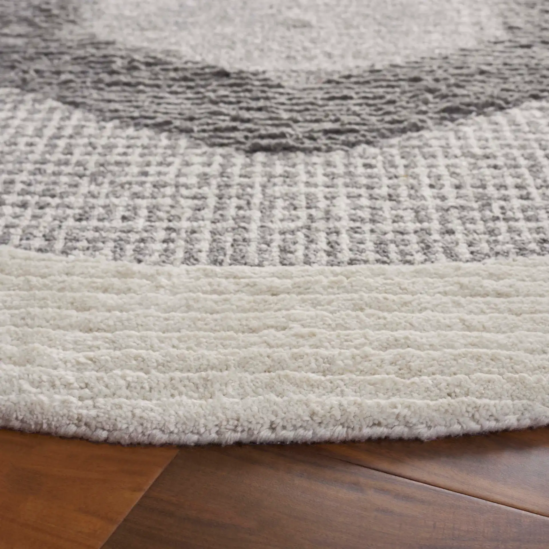 Renewal Concentric Medallion Hand-Tufted Rug in Dark Gray / Ivory in a styled room