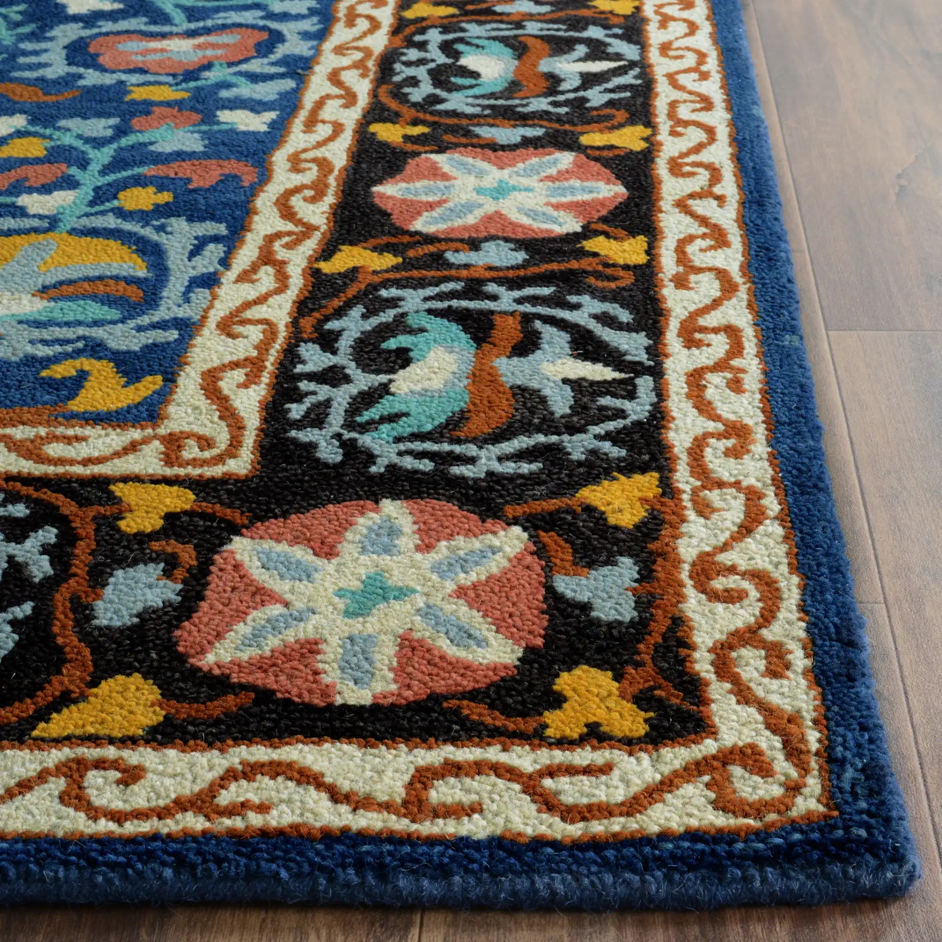 Roslyn Floral Border Hand-Tufted Wool Rug in Blue / Multicolor in a styled room