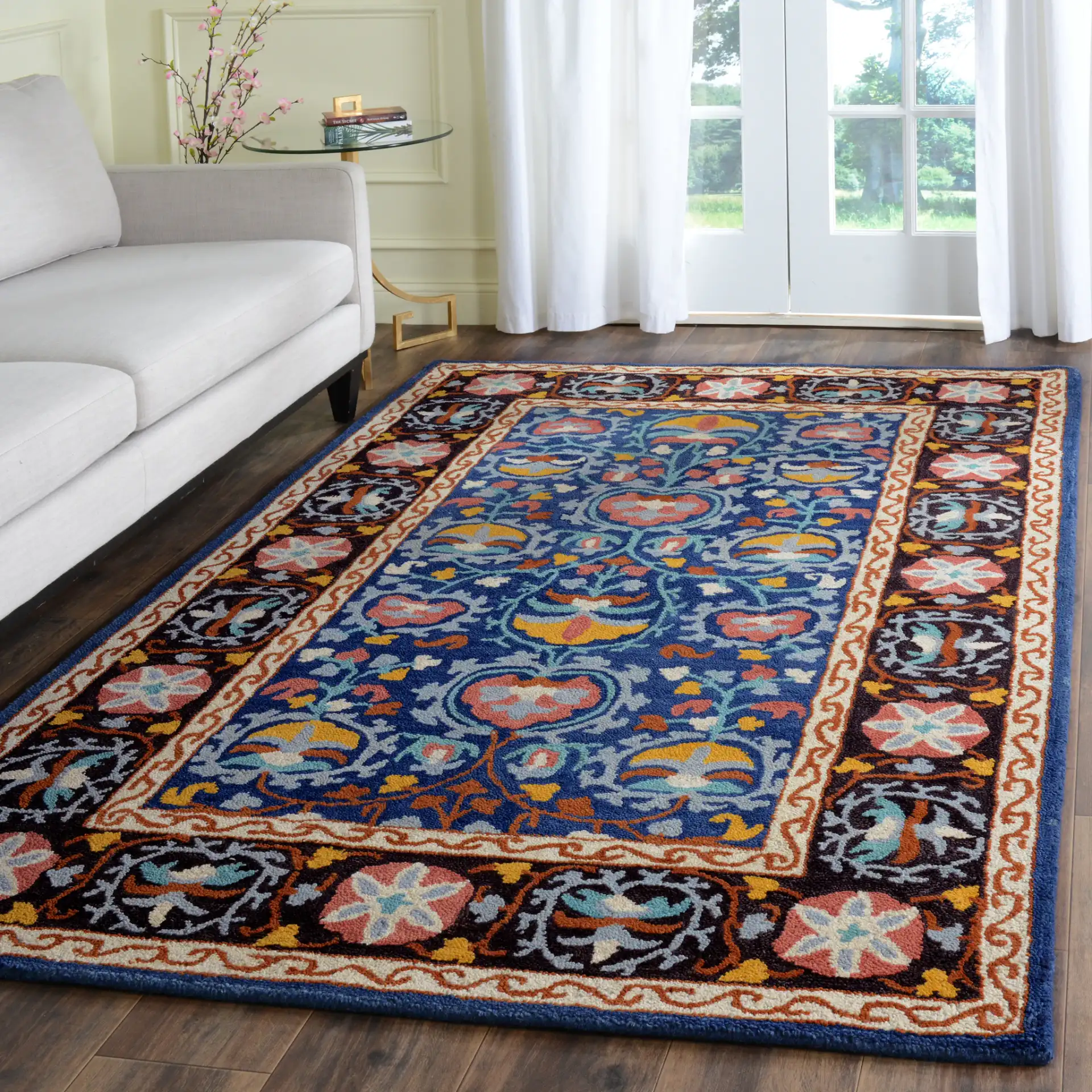 Roslyn Floral Border Hand-Tufted Wool Rug in Blue / Multicolor in a styled room