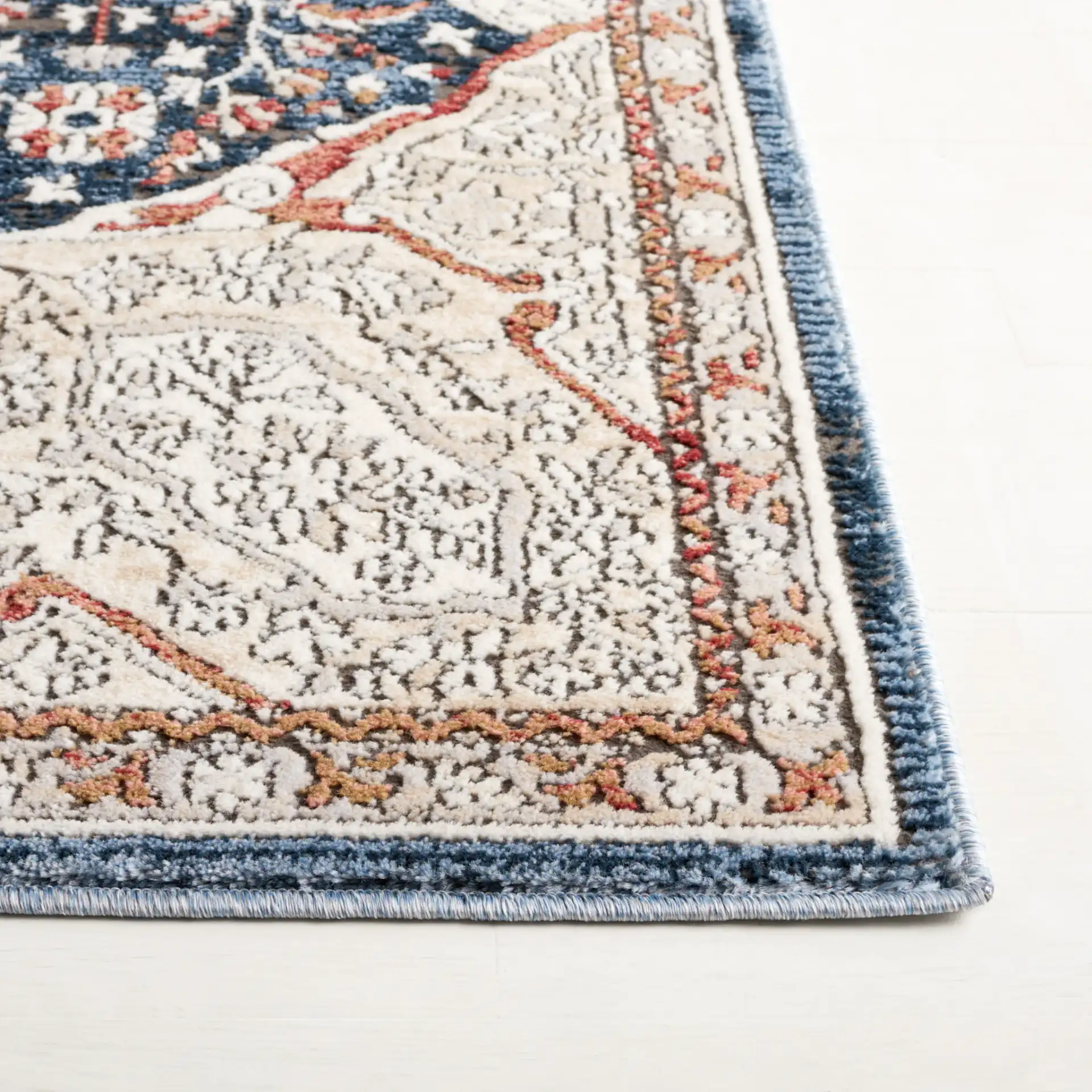 Rosewood Framed Medallion Rug in Ivory / Blue in a styled room