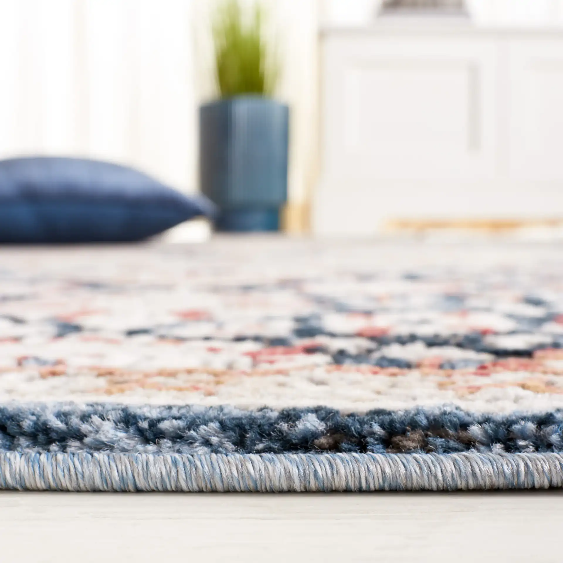 Rosewood Framed Medallion Rug in Ivory / Blue in a styled room