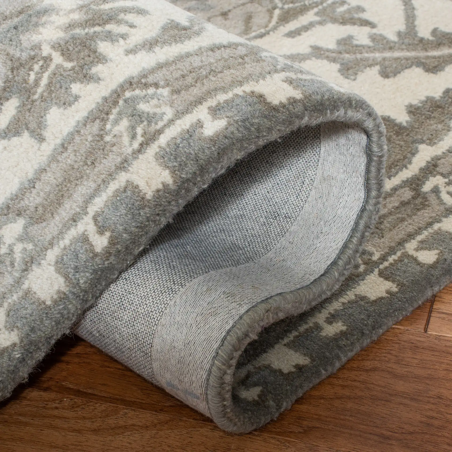 Royalty Palmette Bordered Hand-Tufted Wool Rug in Gray / Cream in a styled room