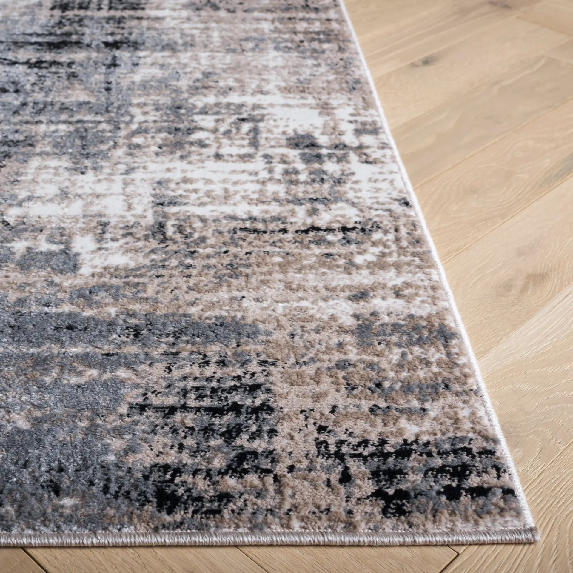 Sable Distressed Abstract Rug in Ivory / Gray Black in a styled room