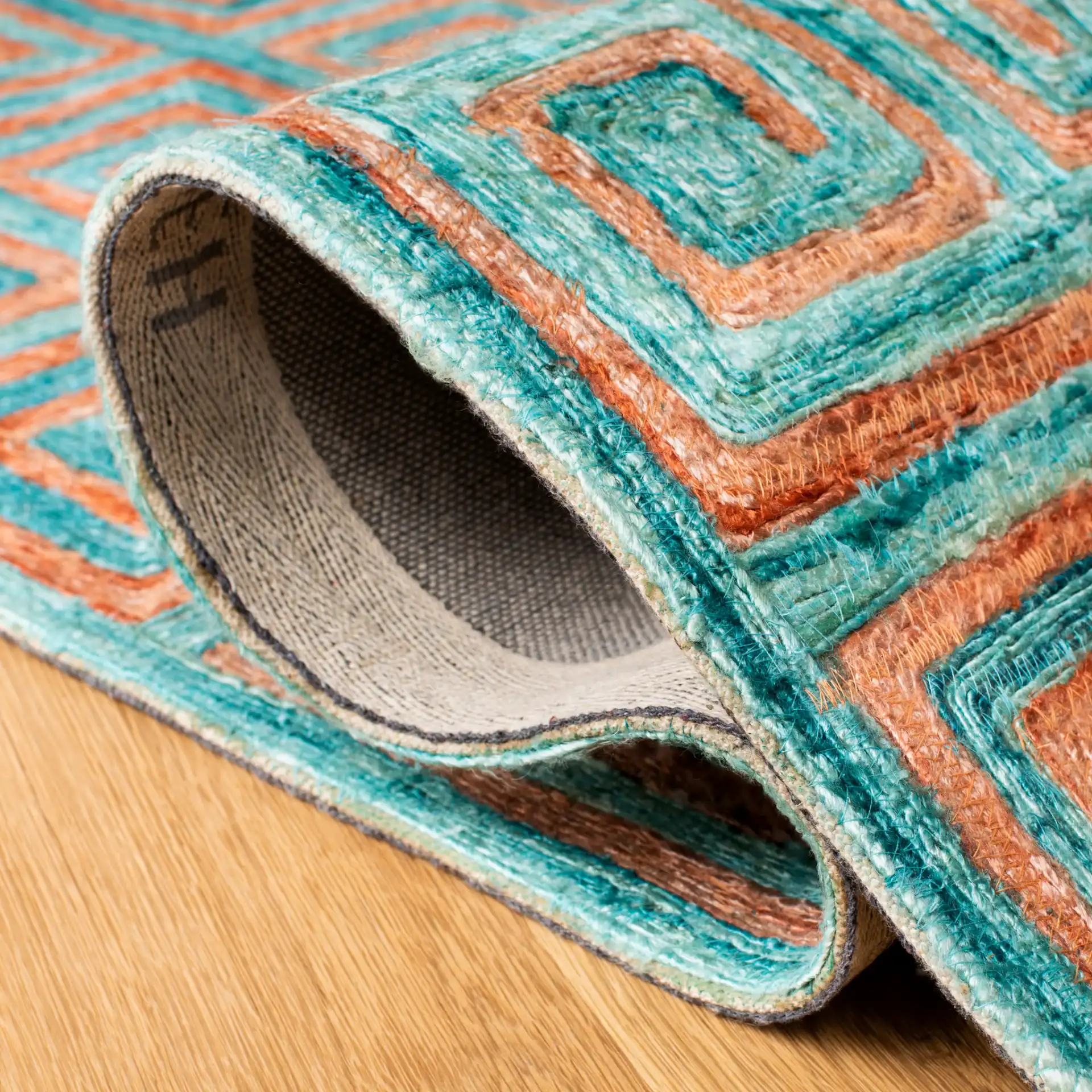 Sahara Greek Key Hand-Tufted Rug in Rust / Aqua in a styled room