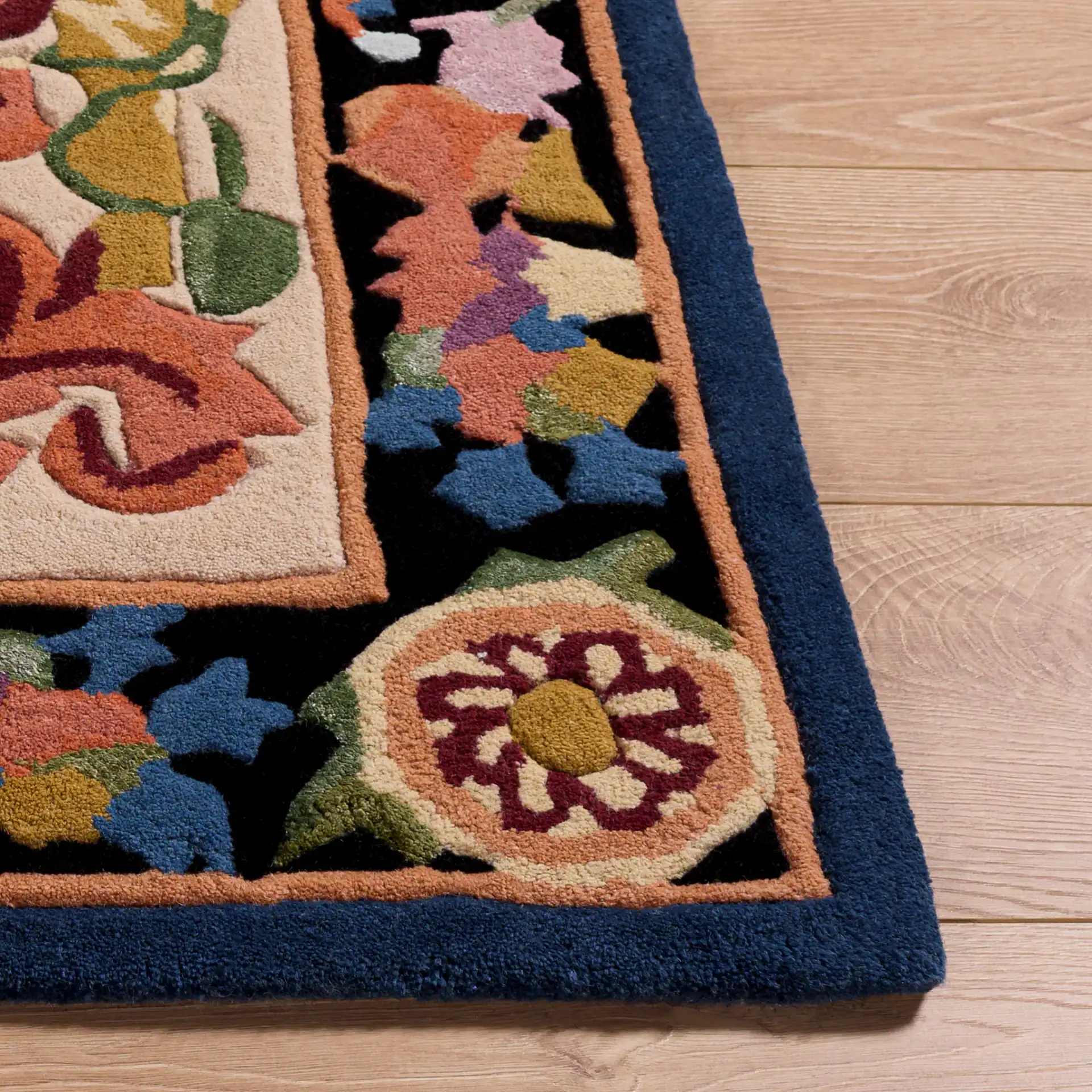 Savonnerie Scroll Medallion Hand-Tufted Rug in Ivory / Orange in a styled room