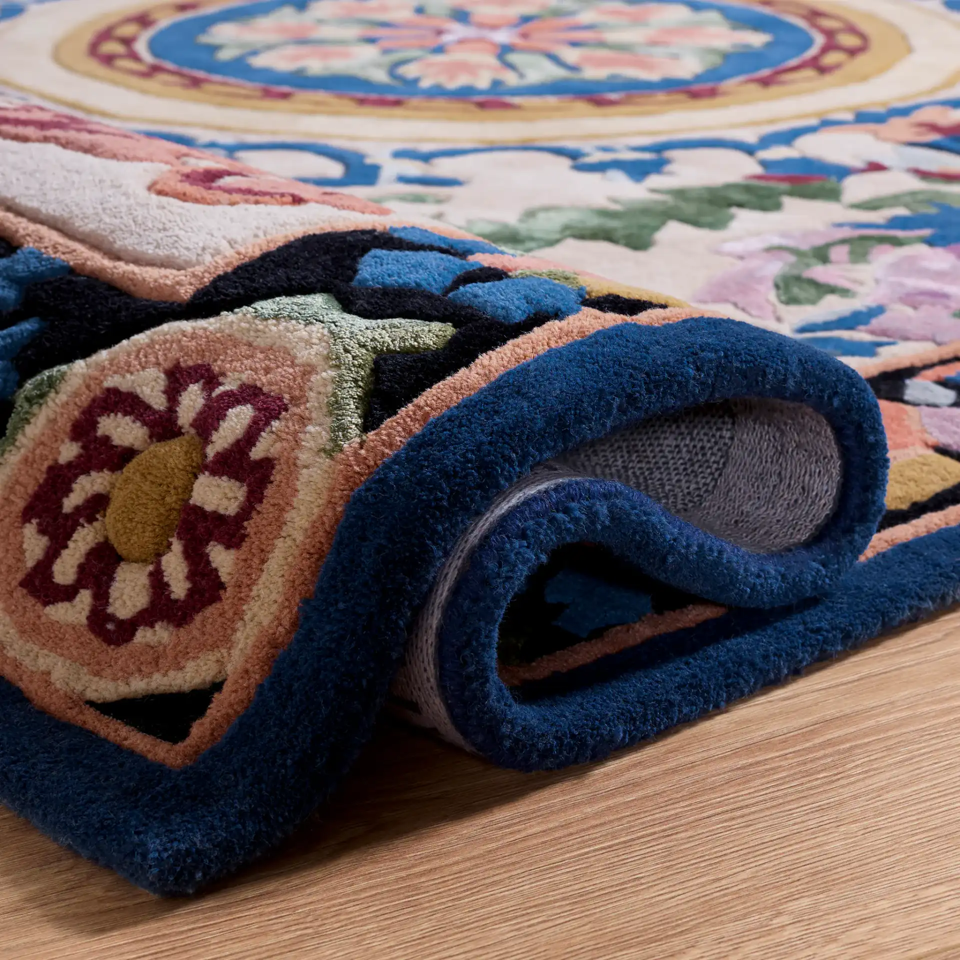 Savonnerie Scroll Medallion Hand-Tufted Rug in Ivory / Orange in a styled room
