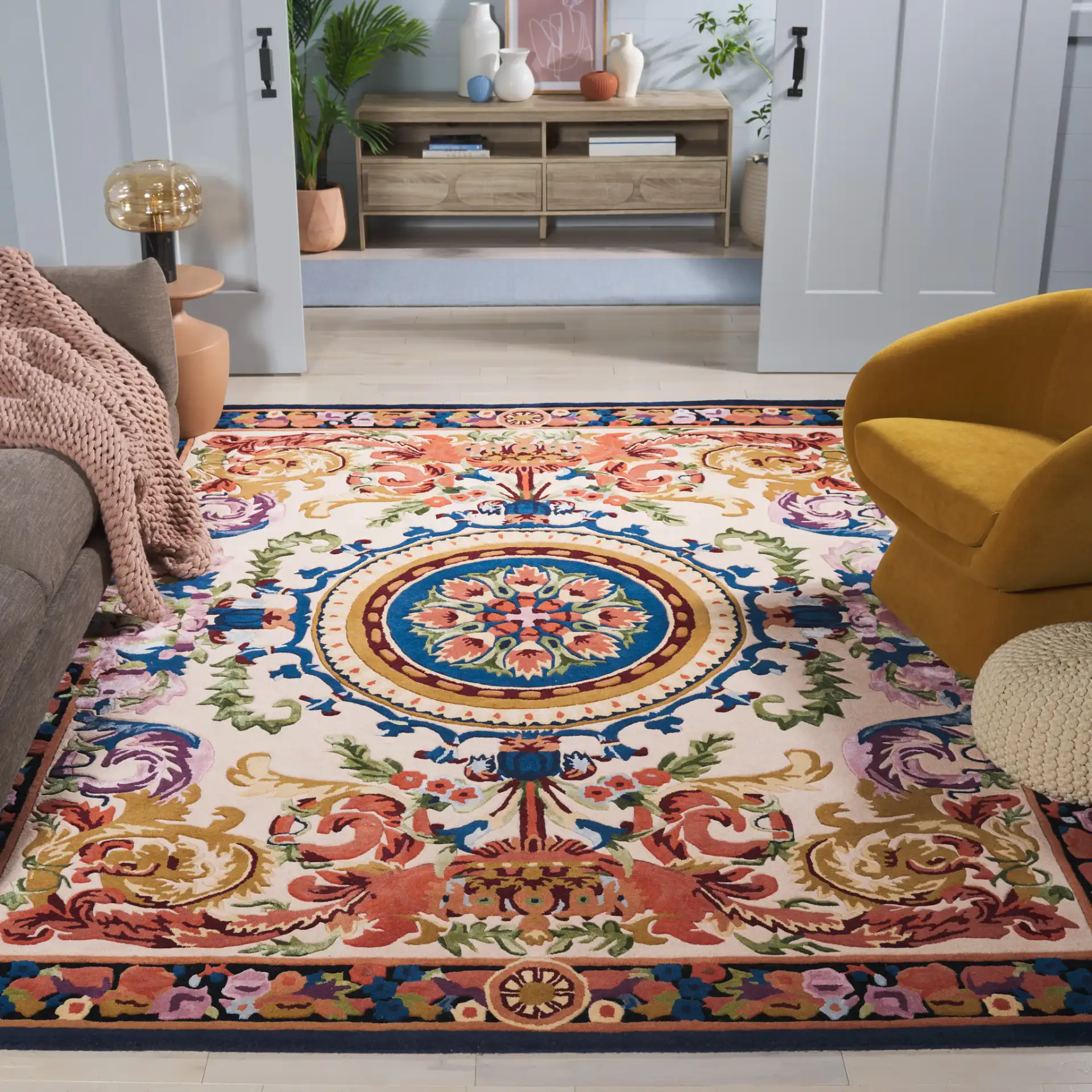 Savonnerie Scroll Medallion Hand-Tufted Rug in Ivory / Orange in a styled room