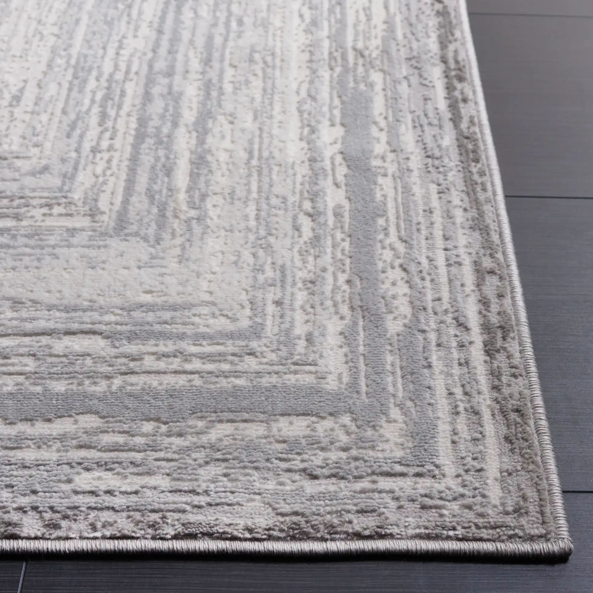 Saylor Concentric Rectangles Rug in Gray / Ivory in a styled room