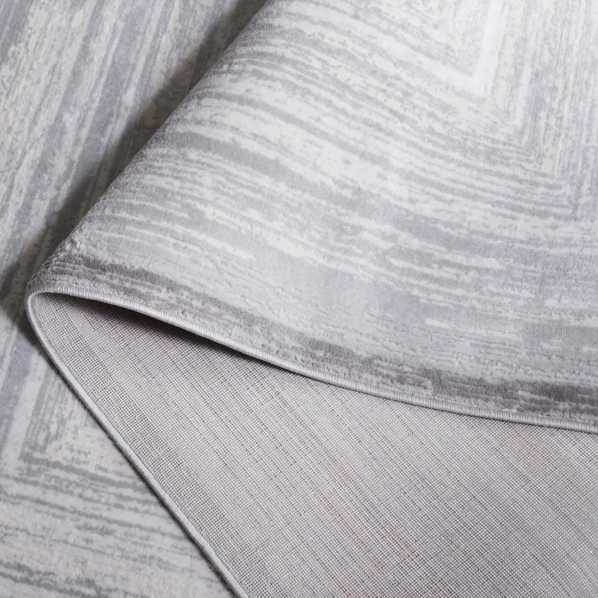 Saylor Concentric Rectangles Rug in Gray / Ivory in a styled room