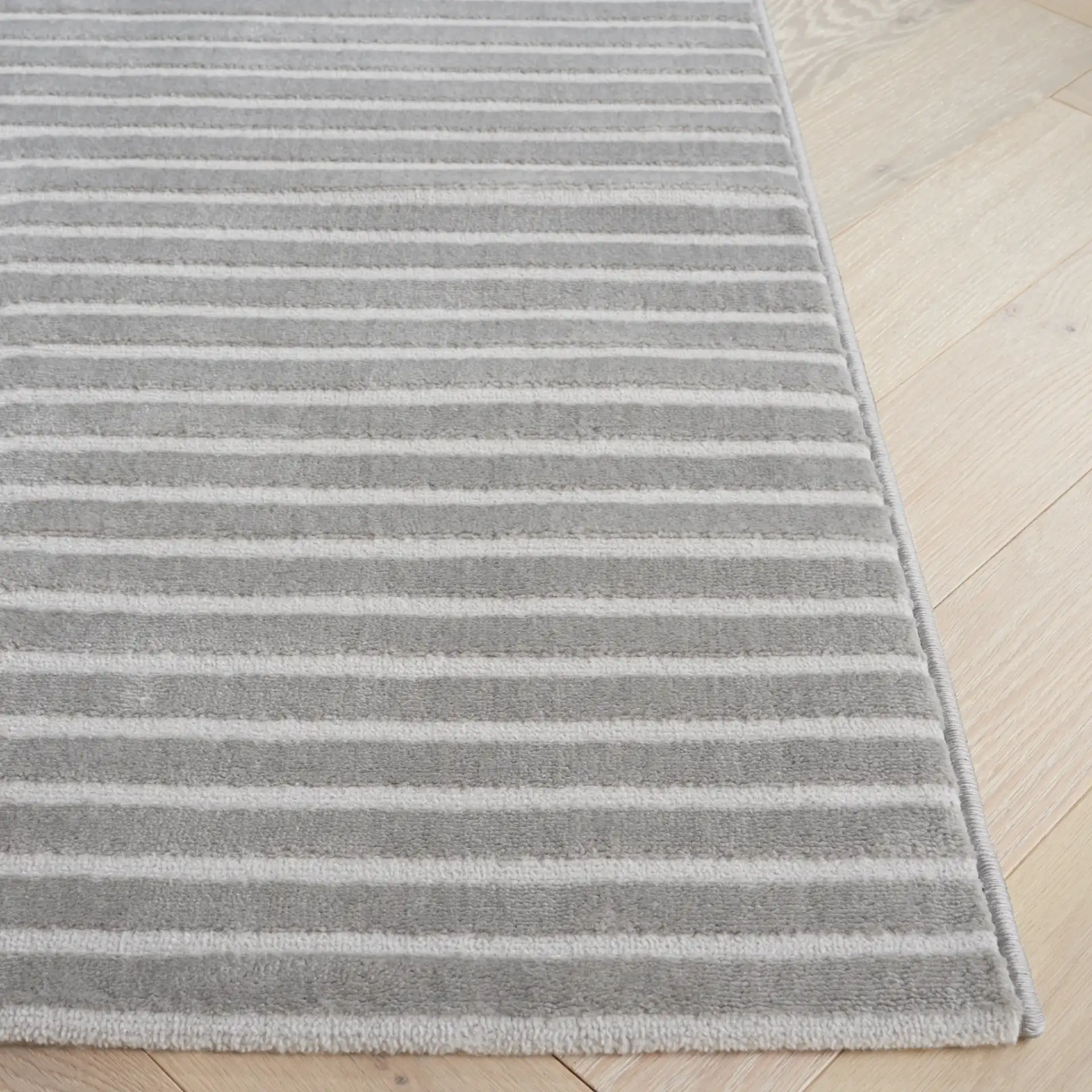 Saylor Arched Stripe Rug in Gray in a styled room