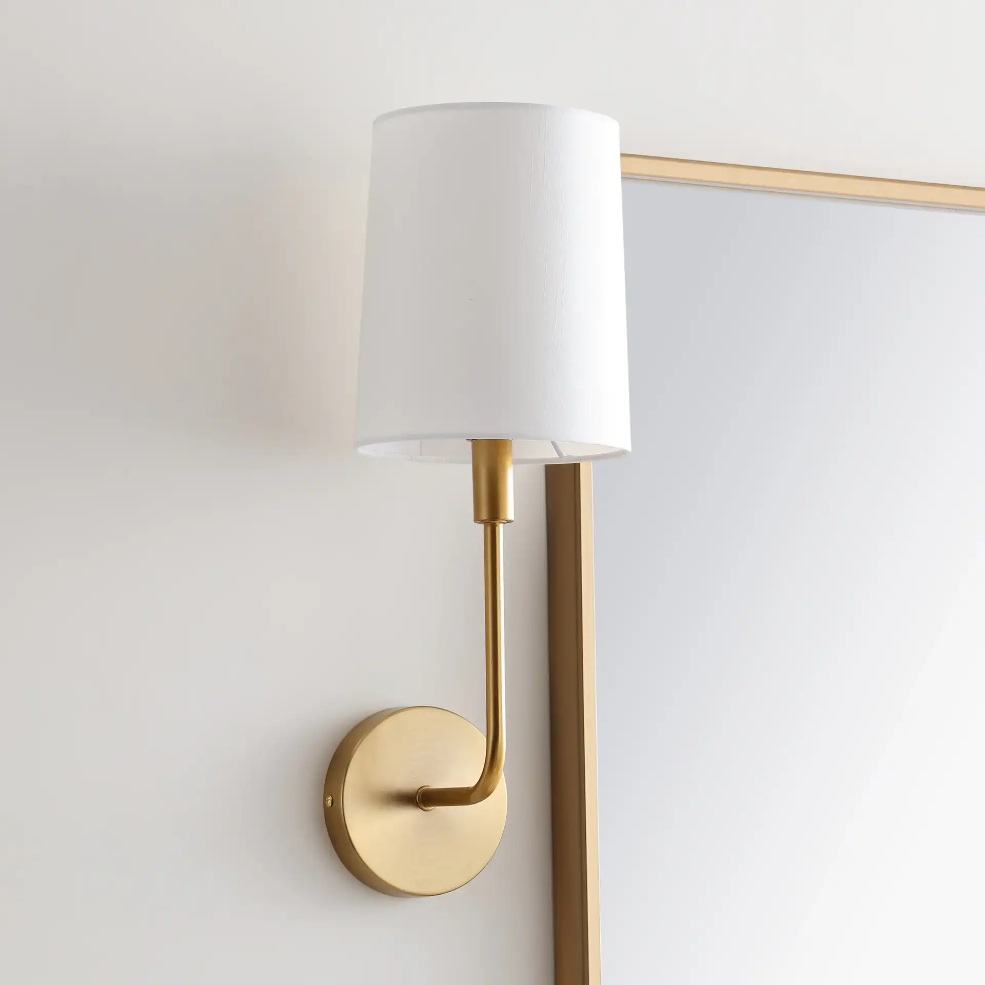 Jaxson Wall Sconce in Ivory / Gold in a styled room