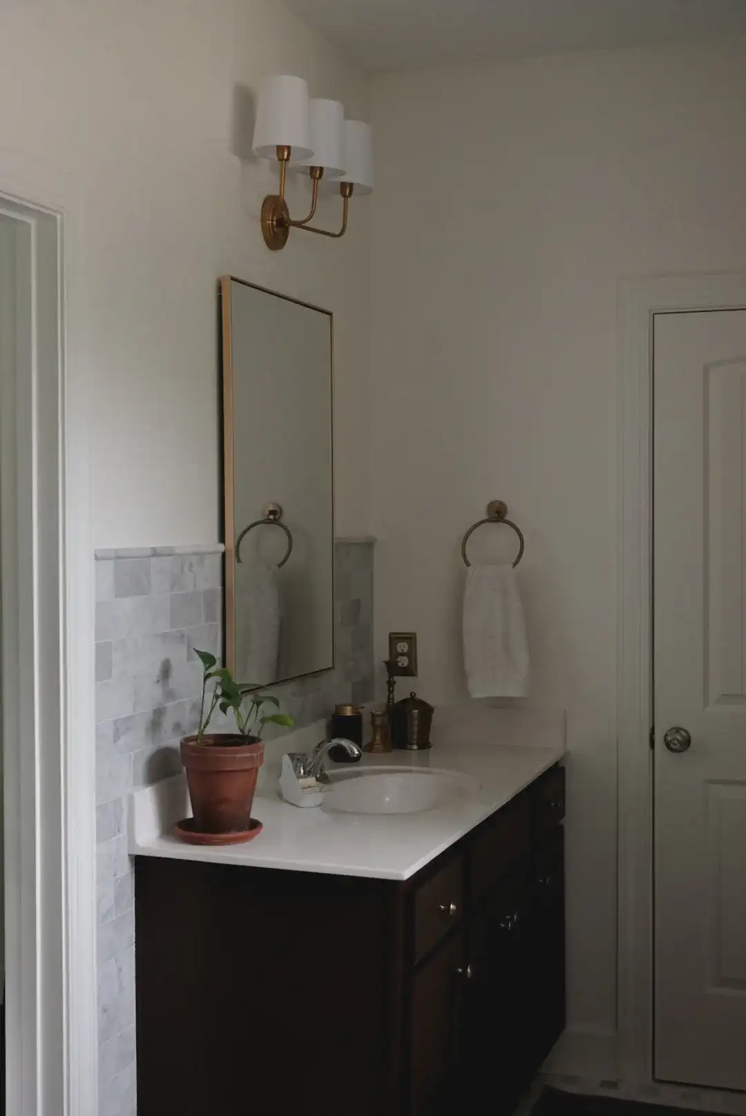 Sawyer Three-Light Wall Sconce in Brass in a styled room