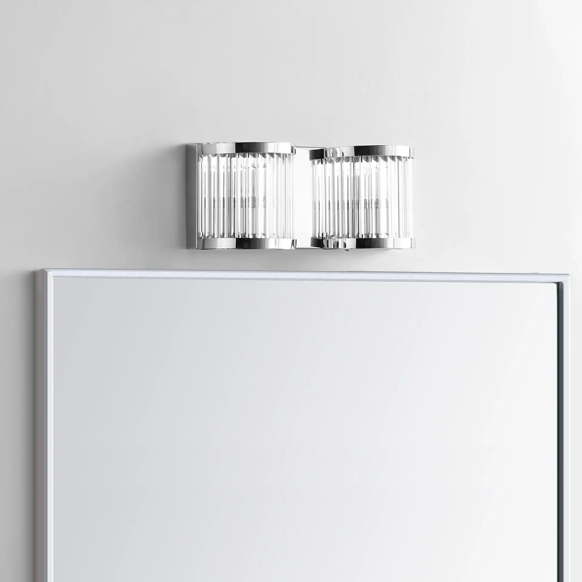 Karter Two-Light Wall Sconce in Chrome / Clear in a styled room