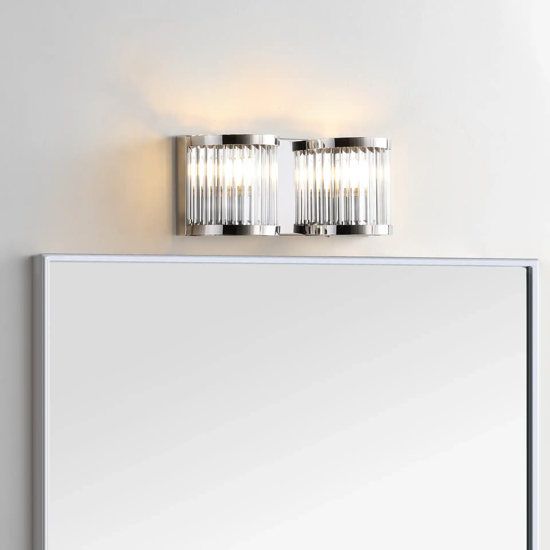 Karter Two-Light Wall Sconce in Chrome / Clear in a styled room