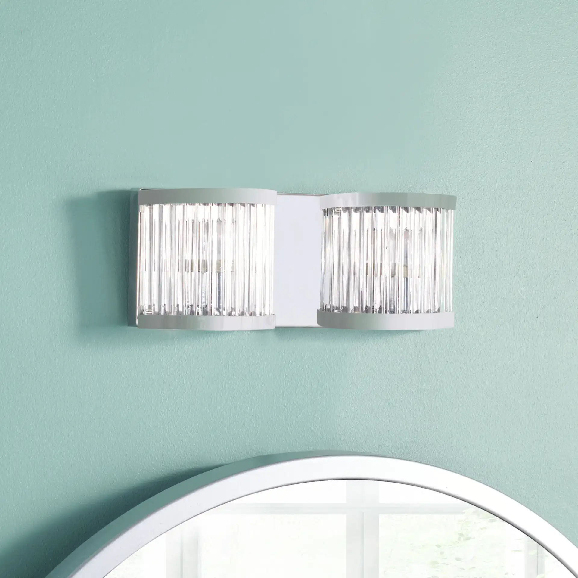 Karter Two-Light Wall Sconce in Chrome / Clear in a styled room