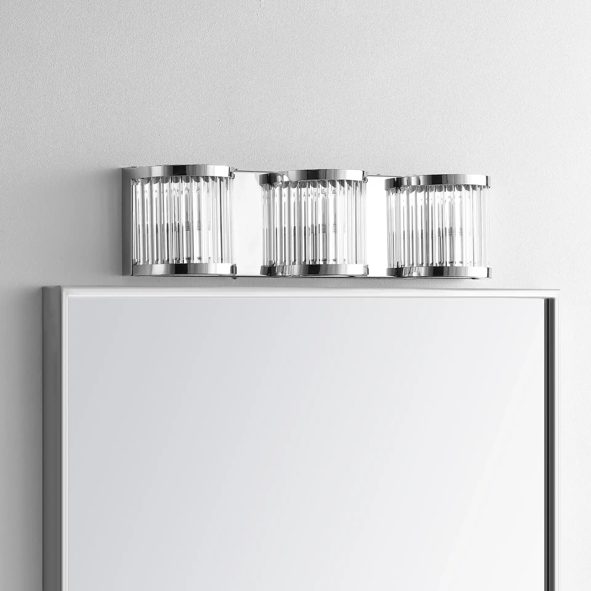 Maverick Three-Light Wall Sconce in Chrome / Clear in a styled room
