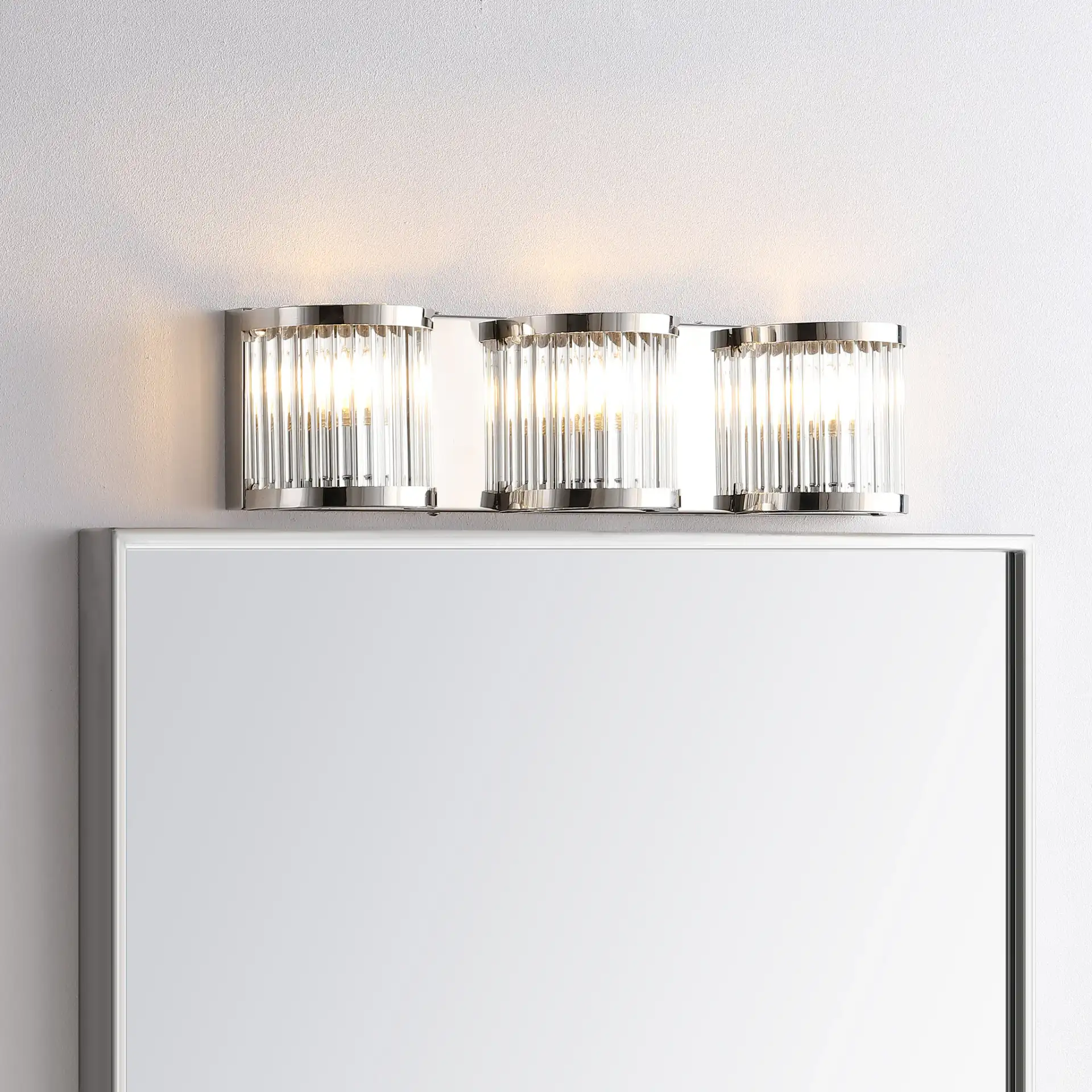 Maverick Three-Light Wall Sconce in Chrome / Clear in a styled room