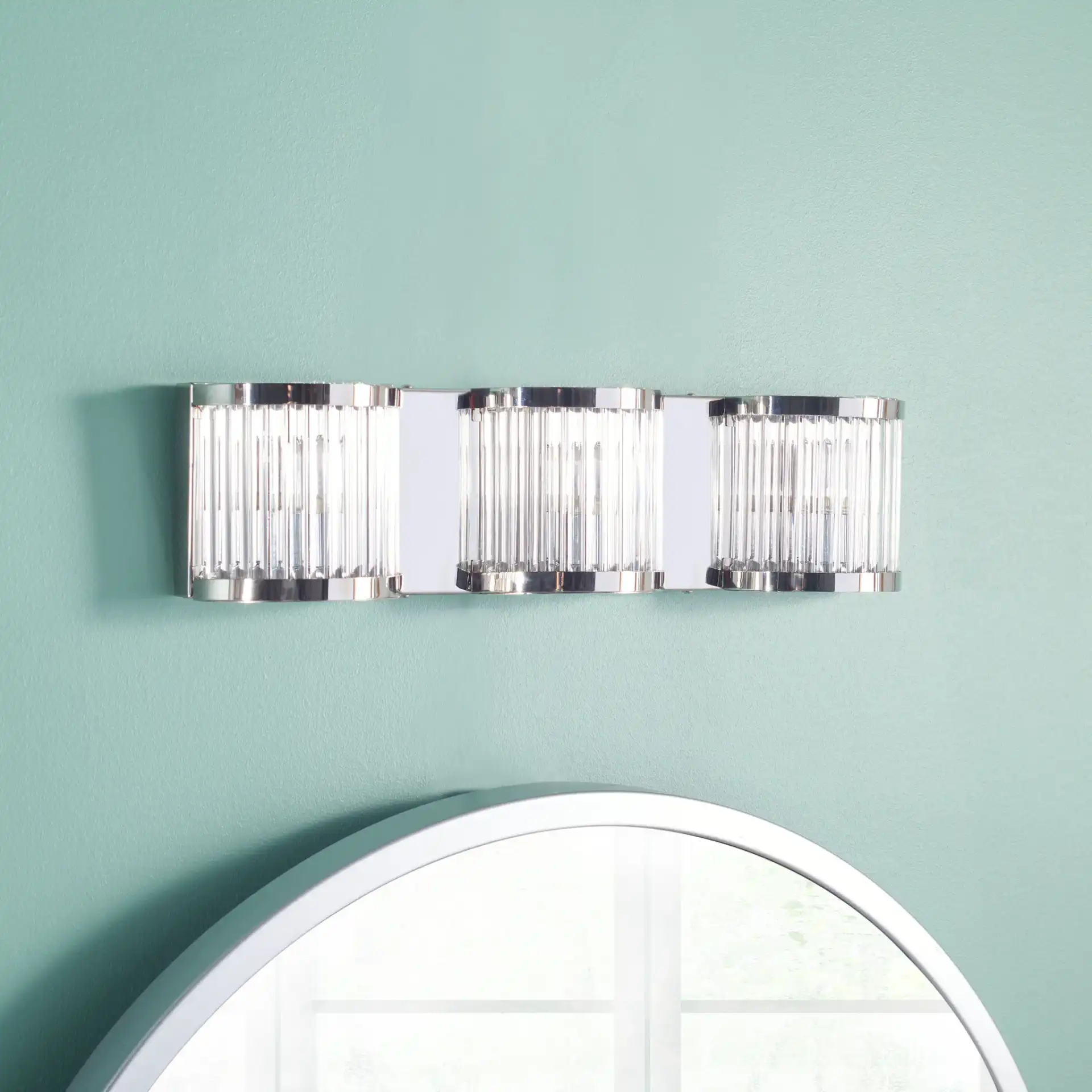 Maverick Three-Light Wall Sconce in Chrome / Clear in a styled room