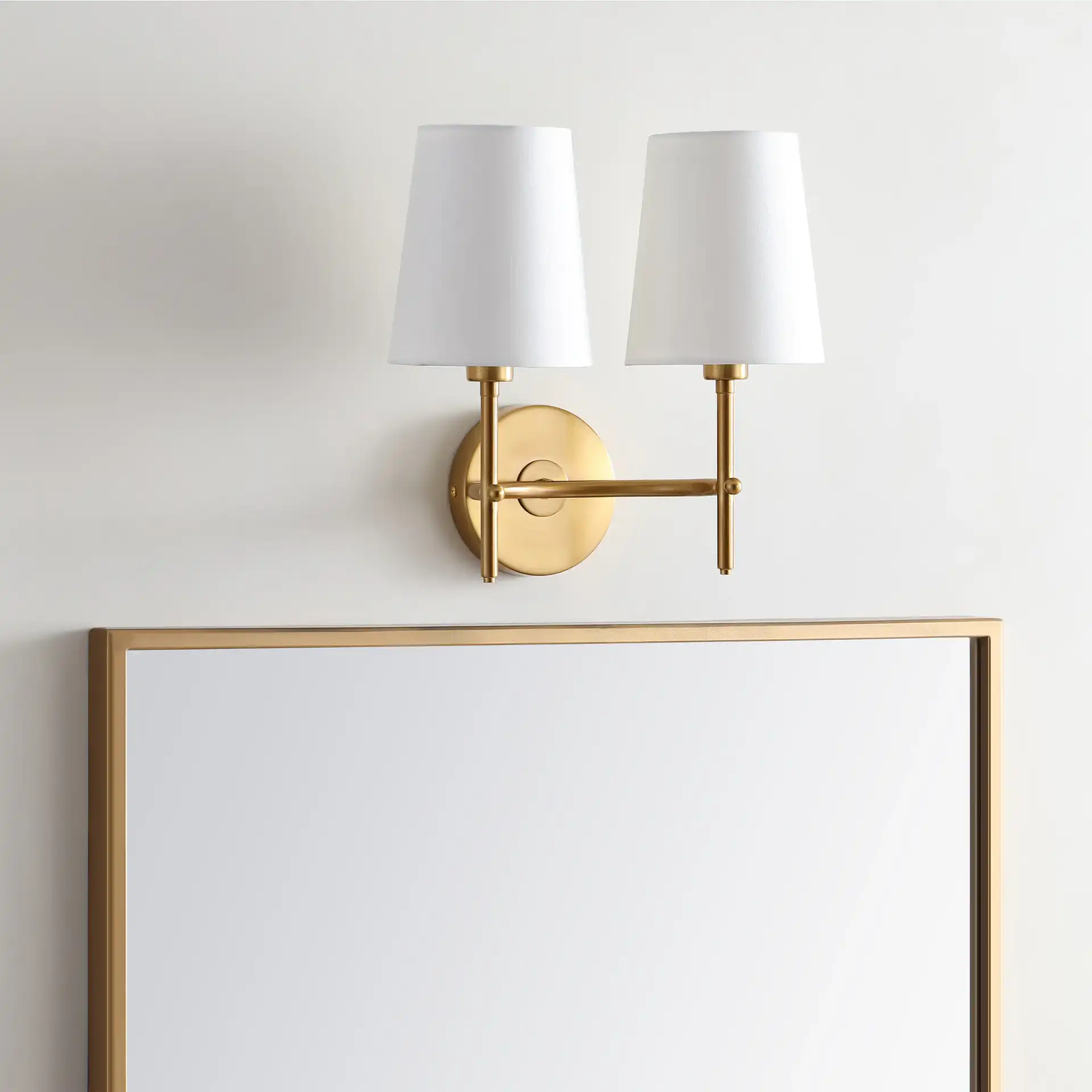 Barrett Two-Light Wall Sconce in Brass in a styled room