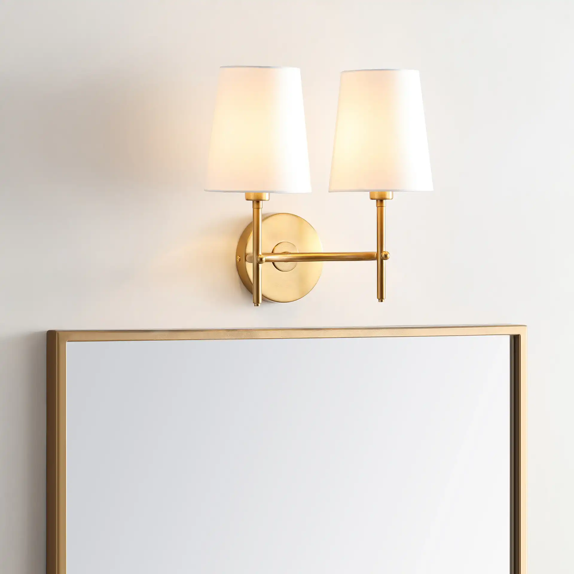 Barrett Two-Light Wall Sconce in Brass in a styled room