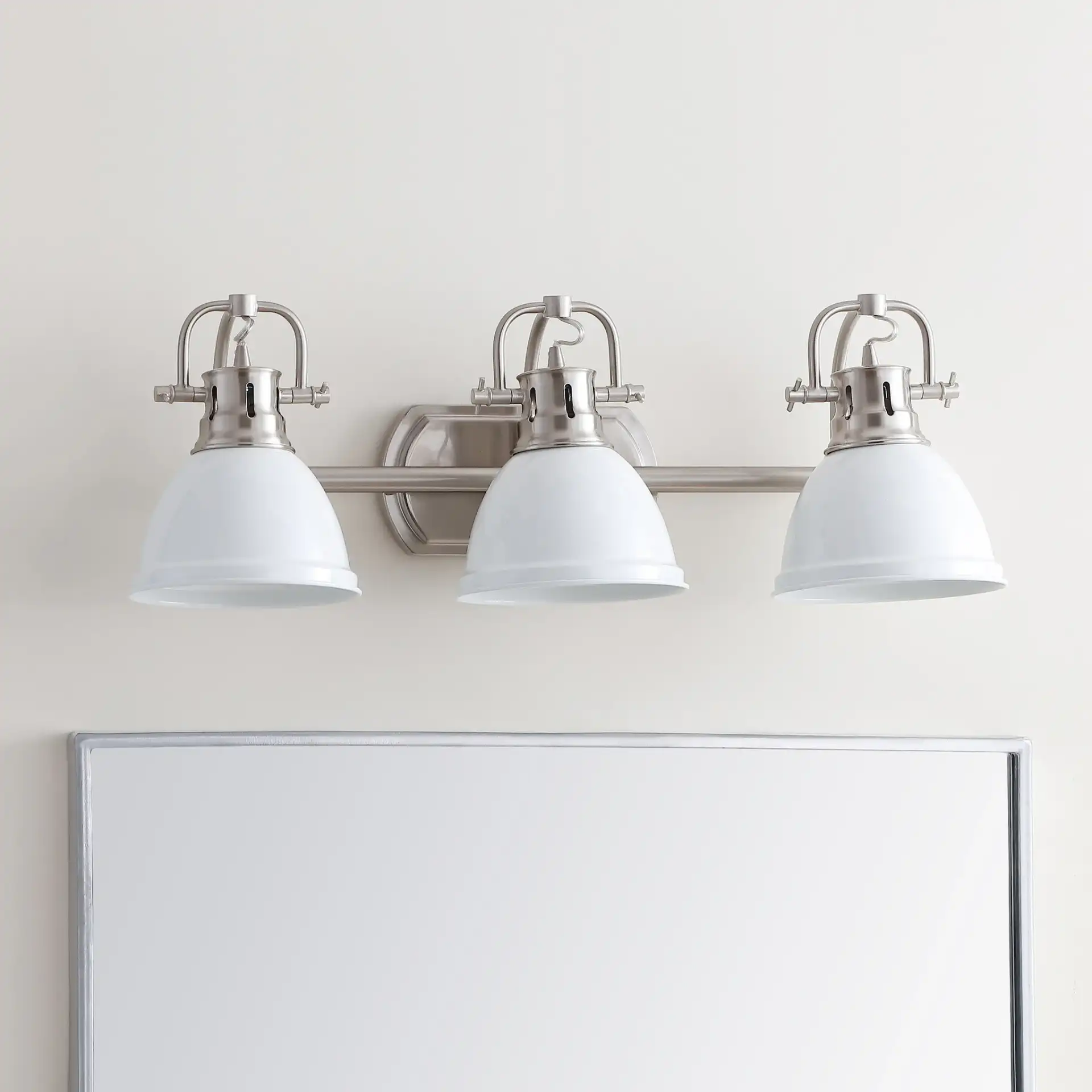 Roland Three-Light Sconce in Nickel in a styled room