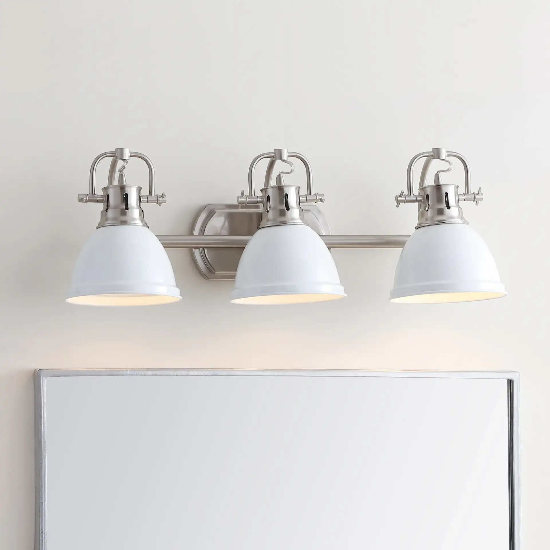 Roland Three-Light Sconce in Nickel in a styled room