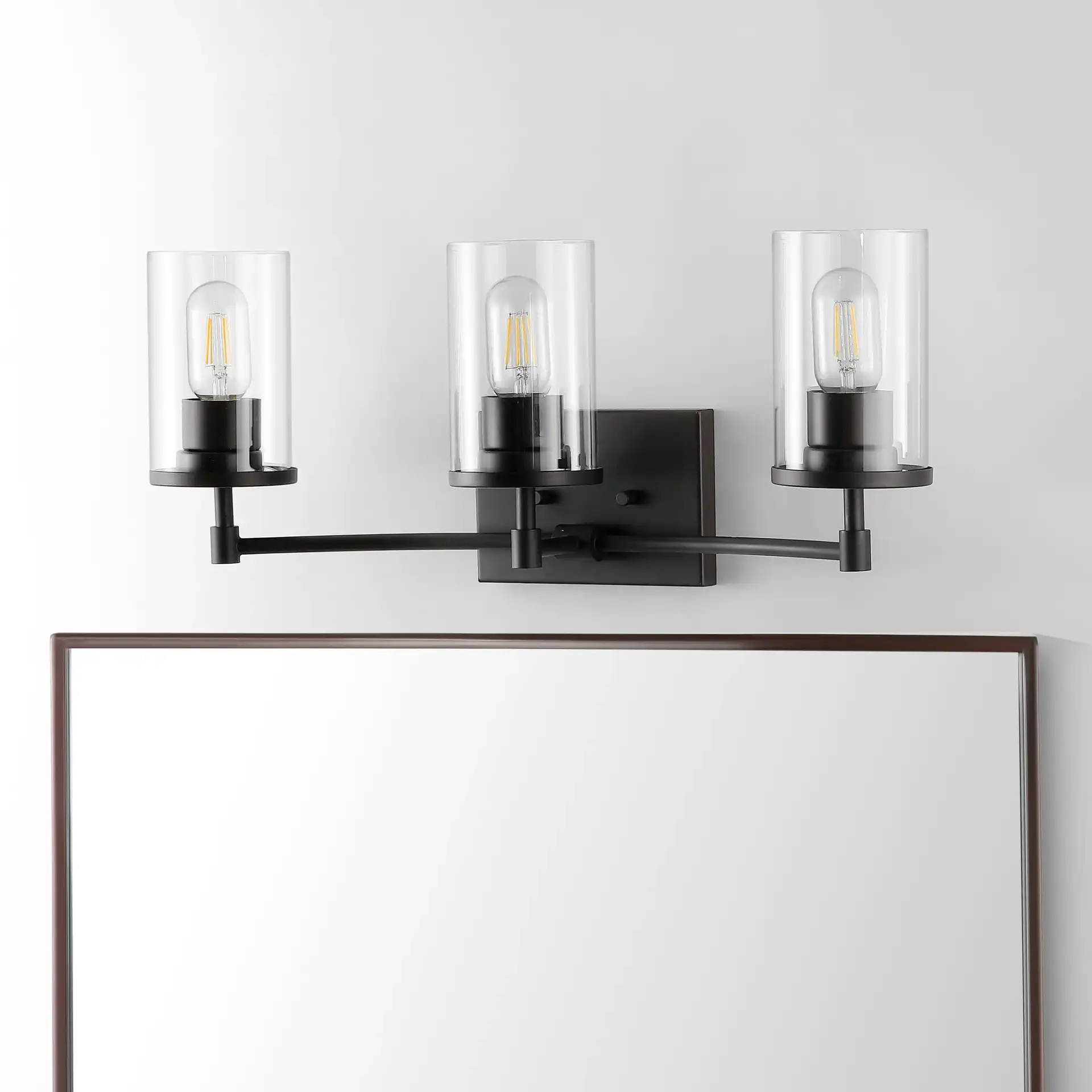 Ronsa Three-Light Wall Sconce in Oil Rub Bronze / Clear in a styled room
