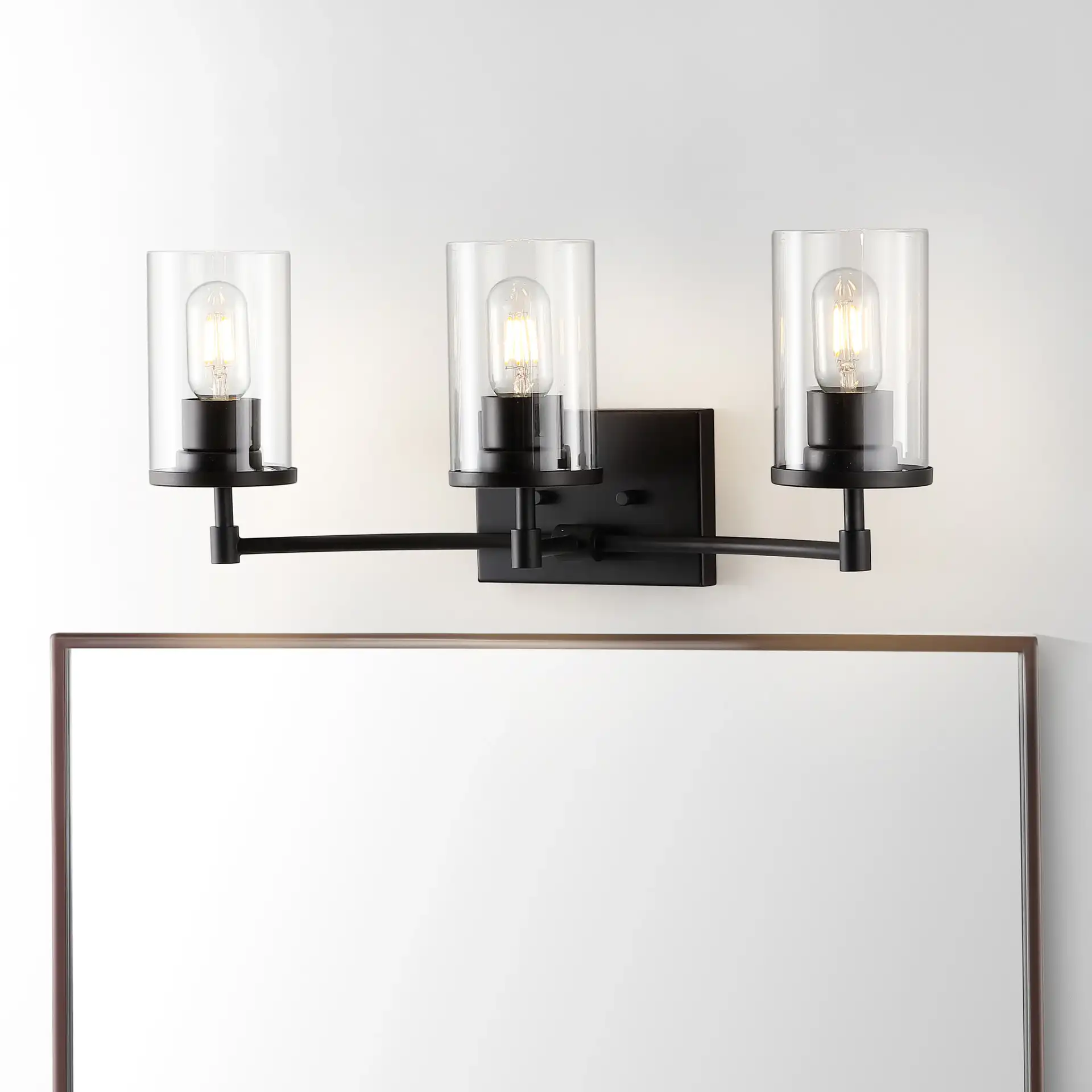 Ronsa Three-Light Wall Sconce in Oil Rub Bronze / Clear in a styled room