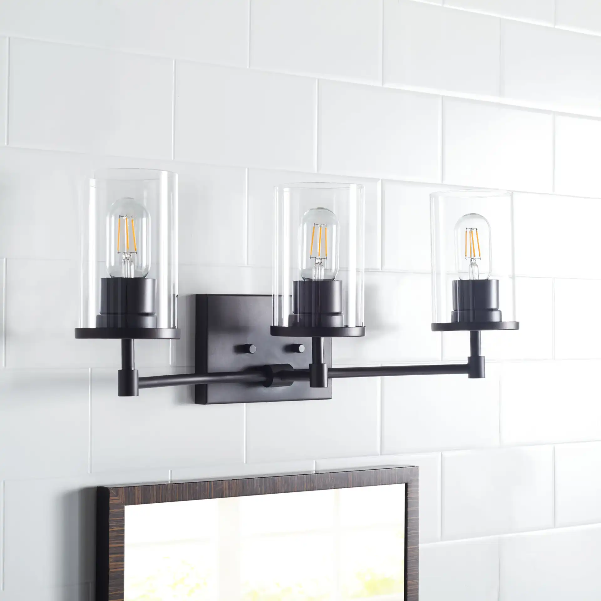 Ronsa Three-Light Wall Sconce in Oil Rub Bronze / Clear in a styled room