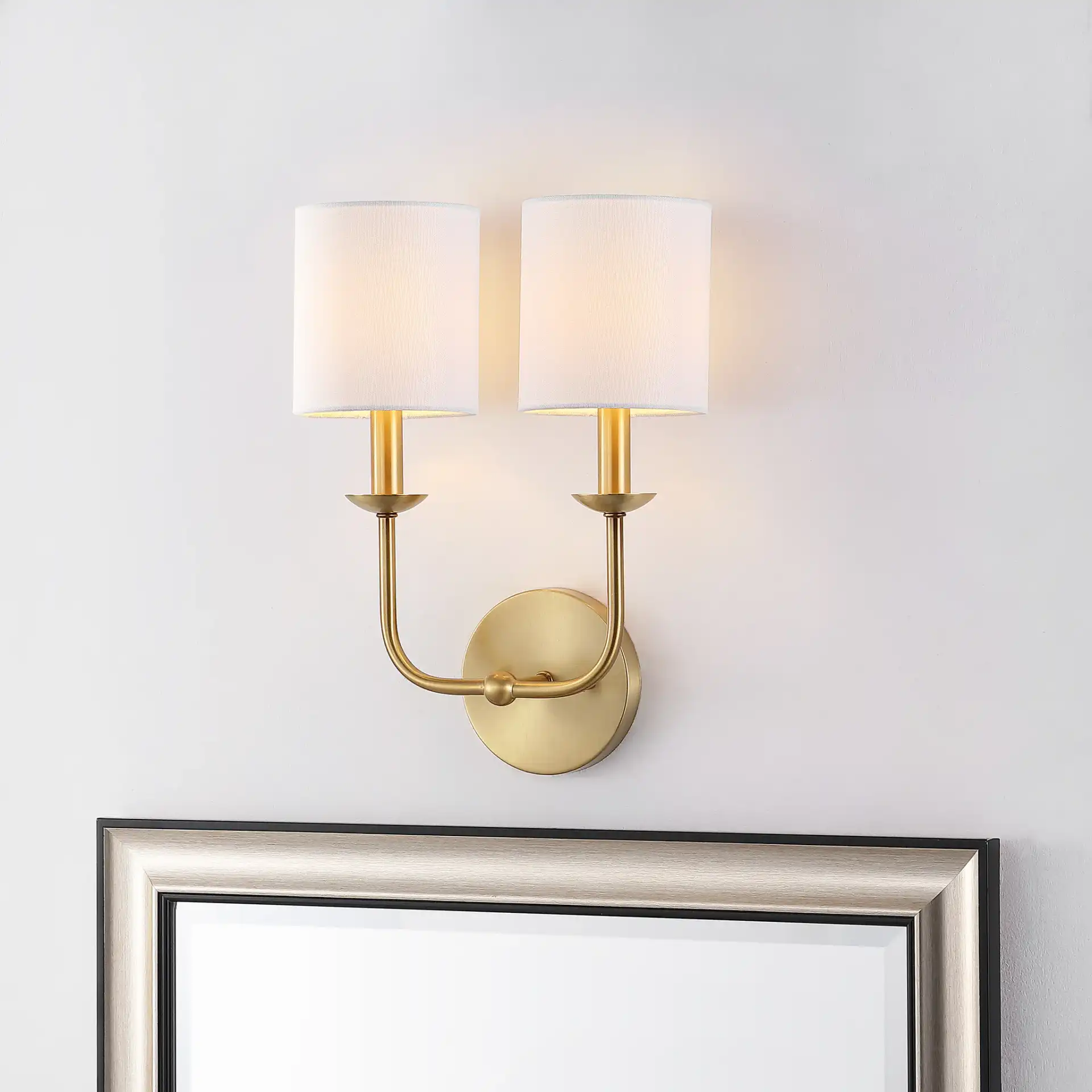 Ferrara Two-Light Wall Sconce in Gold in a styled room