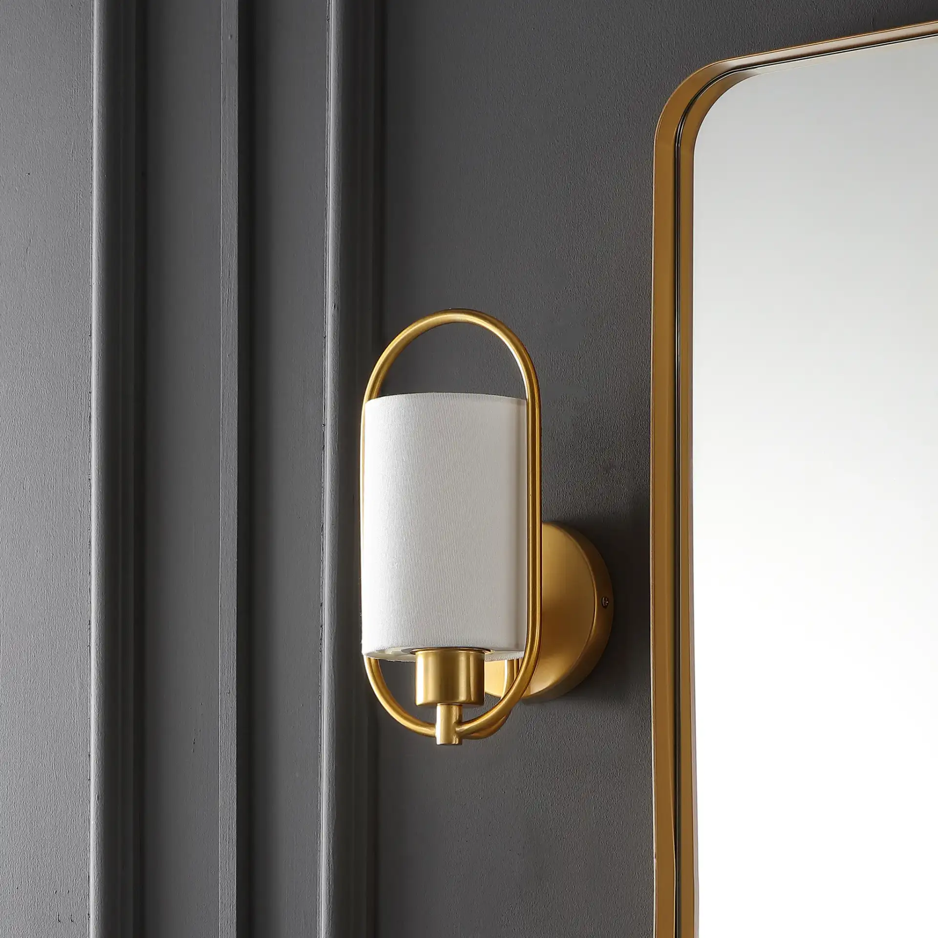Haldea Wall Sconce in Brass in a styled room