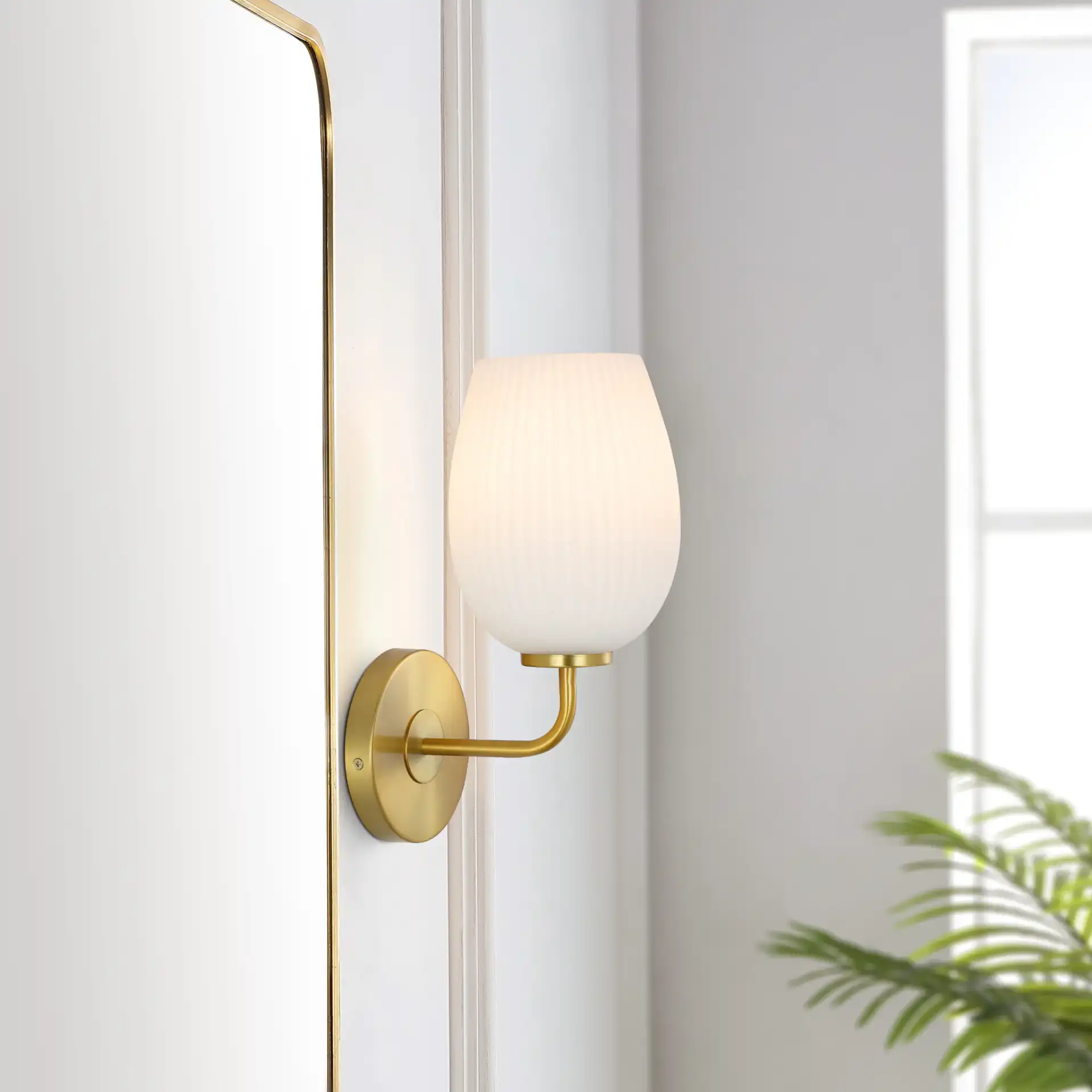 Idina Wall Sconce in Brass / White in a styled room