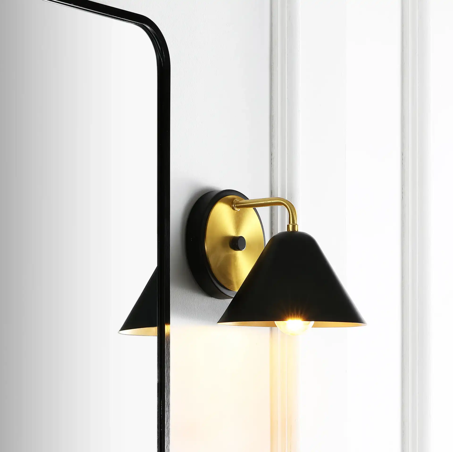 Jynn Wall Sconce in Black / Brass in a styled room