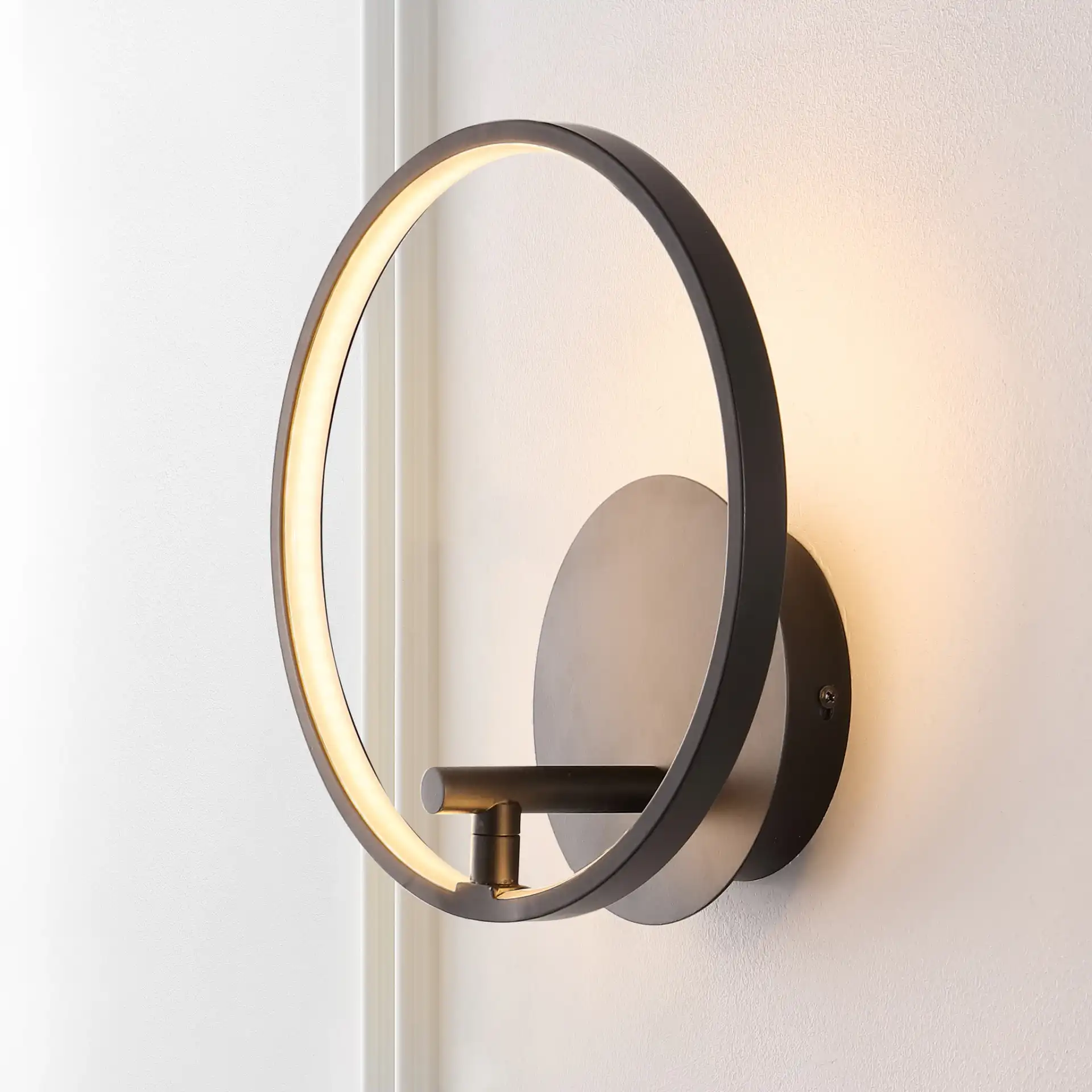 Jolyn Led Wall Sconce in Black in a styled room