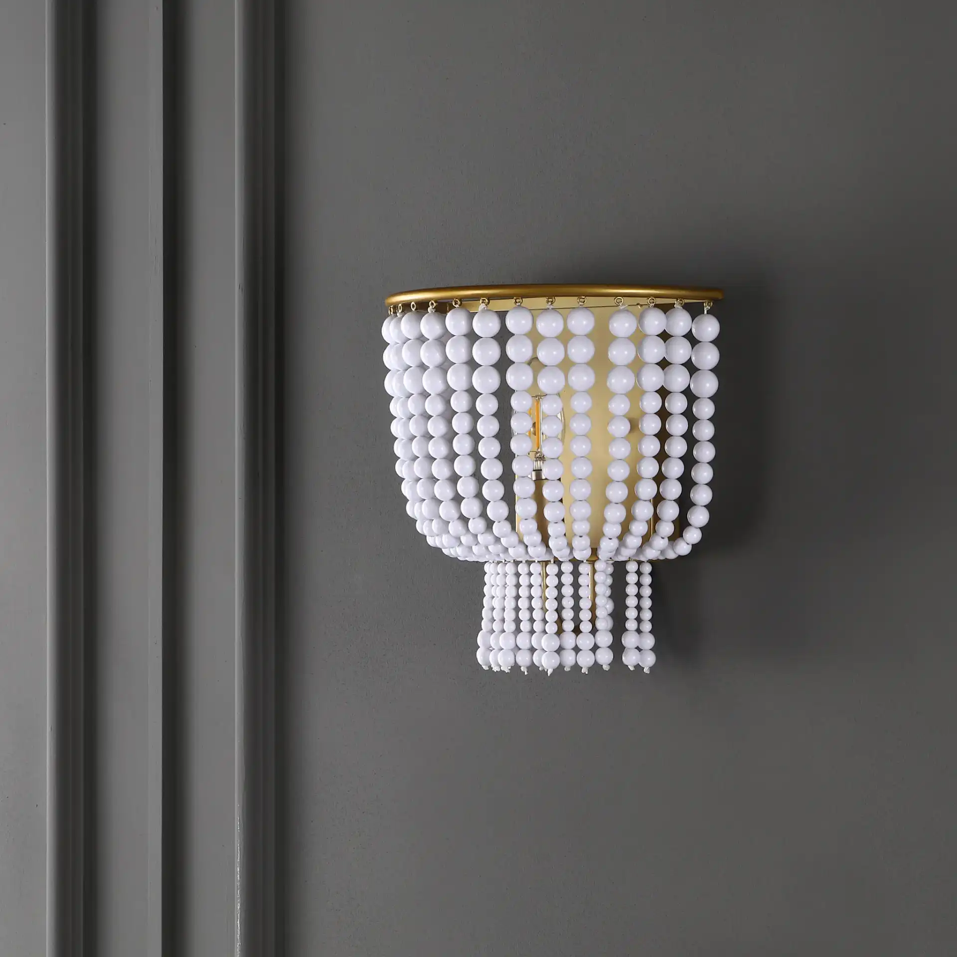 Celyn Wall Sconce in White / Brass in a styled room