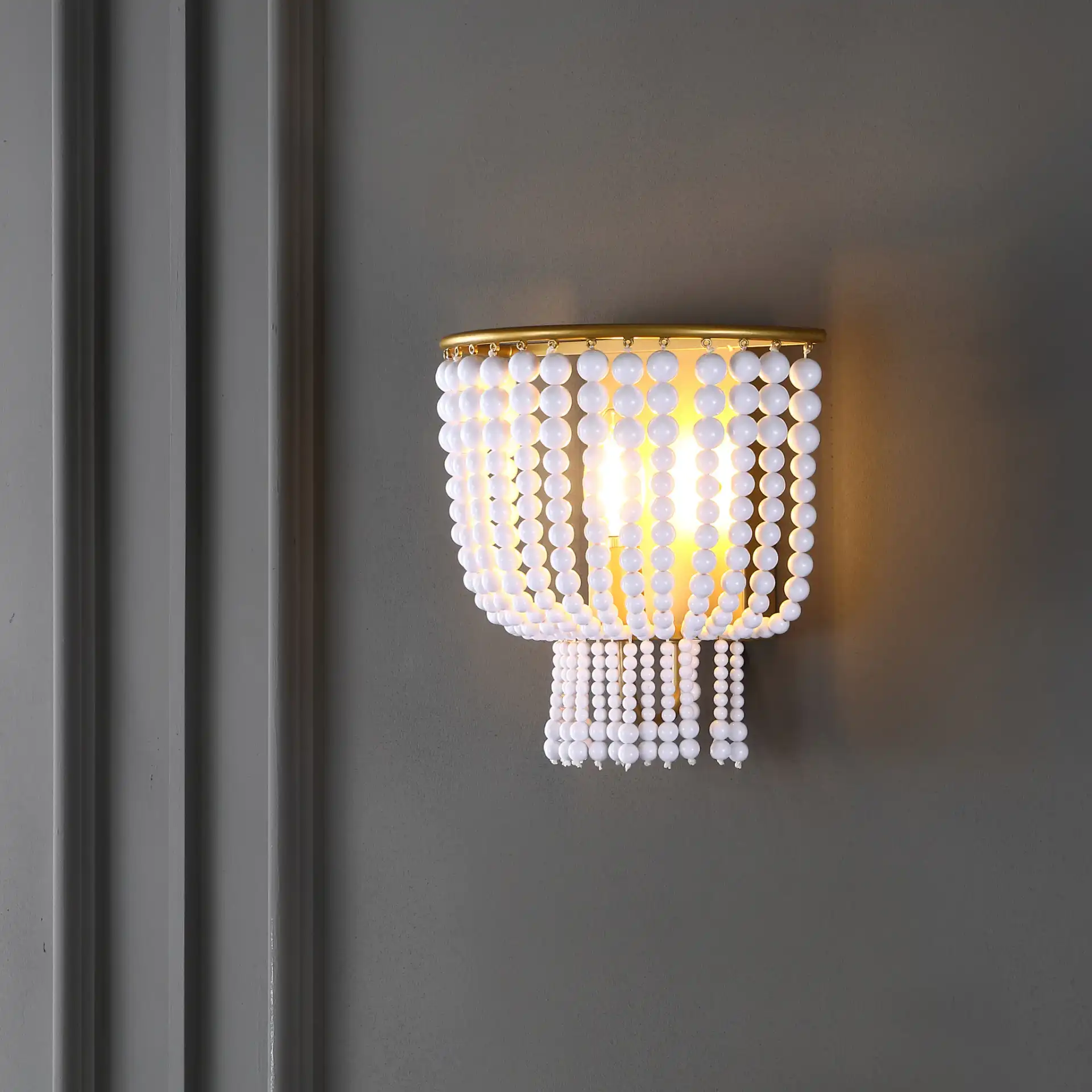 Celyn Wall Sconce in White / Brass in a styled room