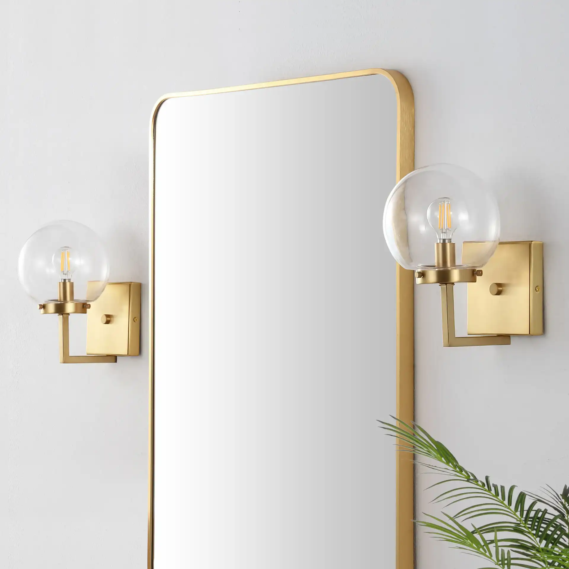Ganon Wall Sconce (Set Of 2) in Brass / Clear in a styled room