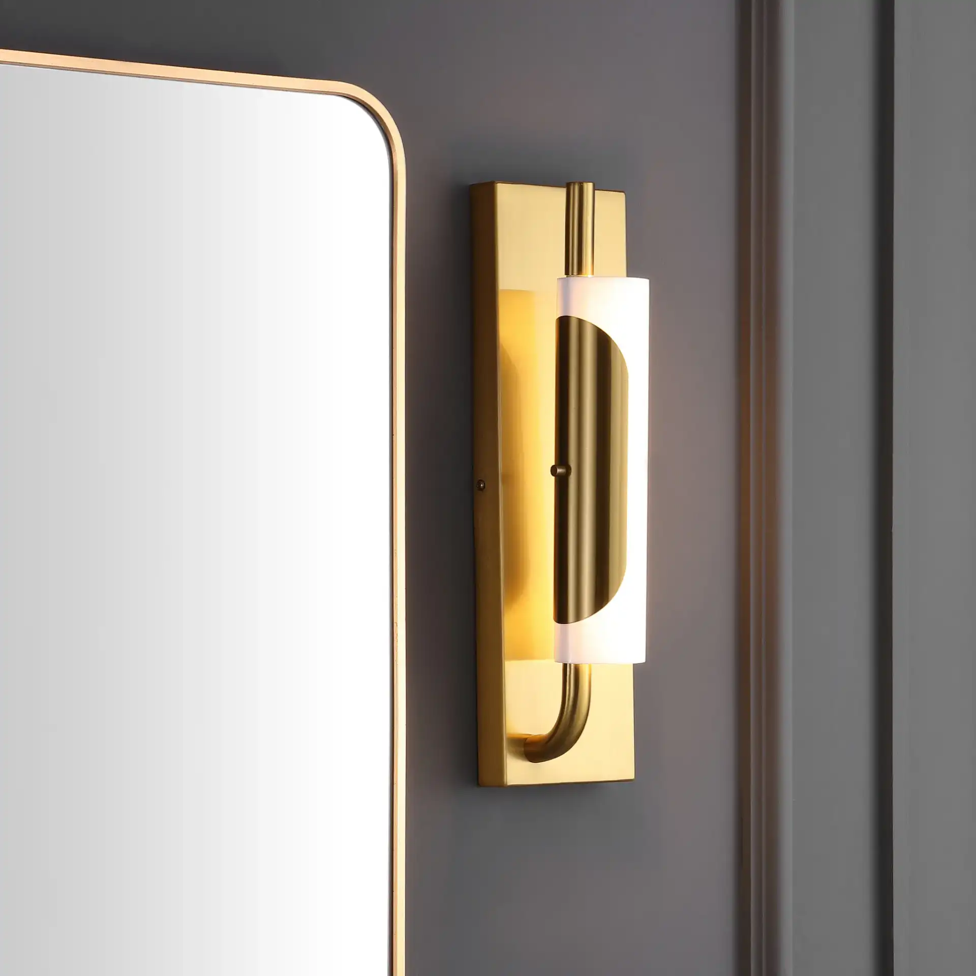 Momo Led Wall Sconce in Brass in a styled room