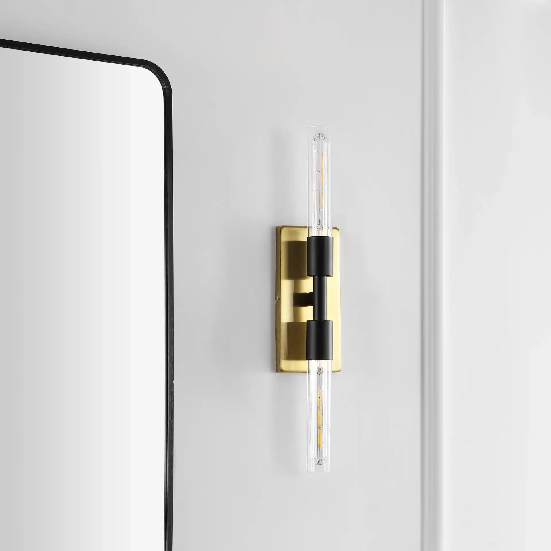 Nyx Two-Light Wall Sconce in Brass / Black in a styled room