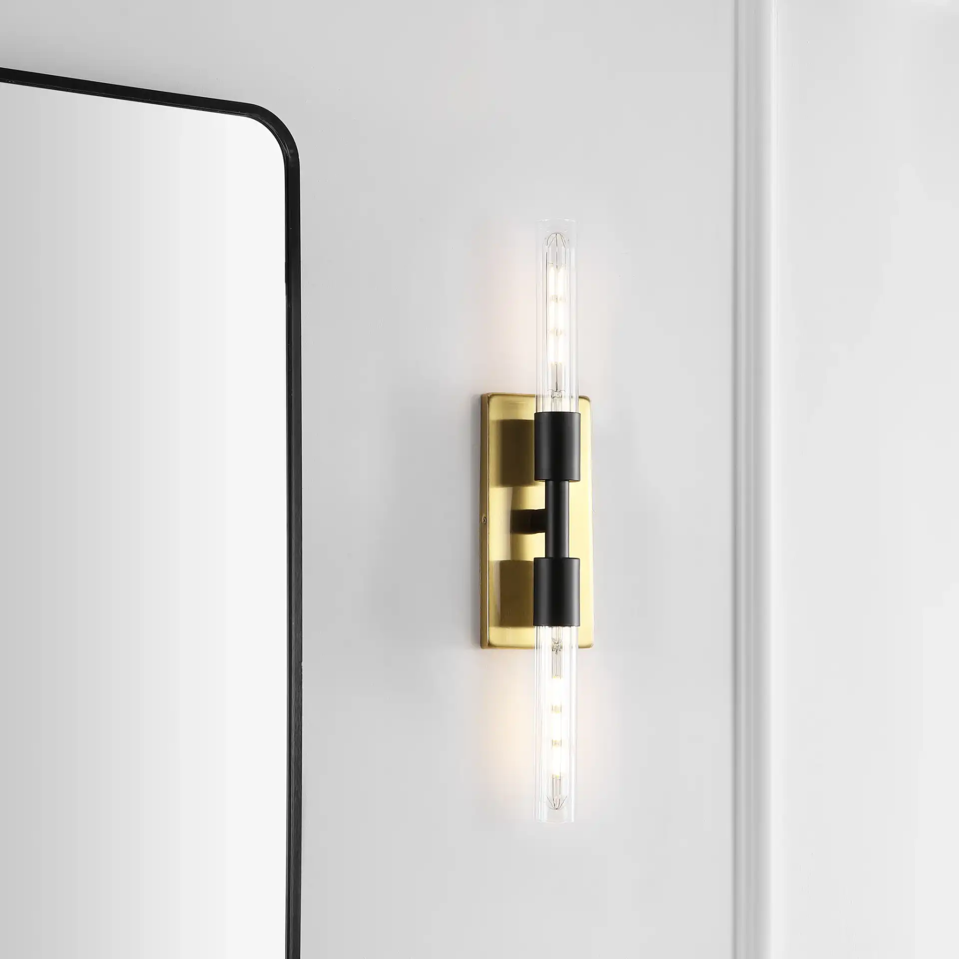 Nyx Two-Light Wall Sconce in Brass / Black in a styled room