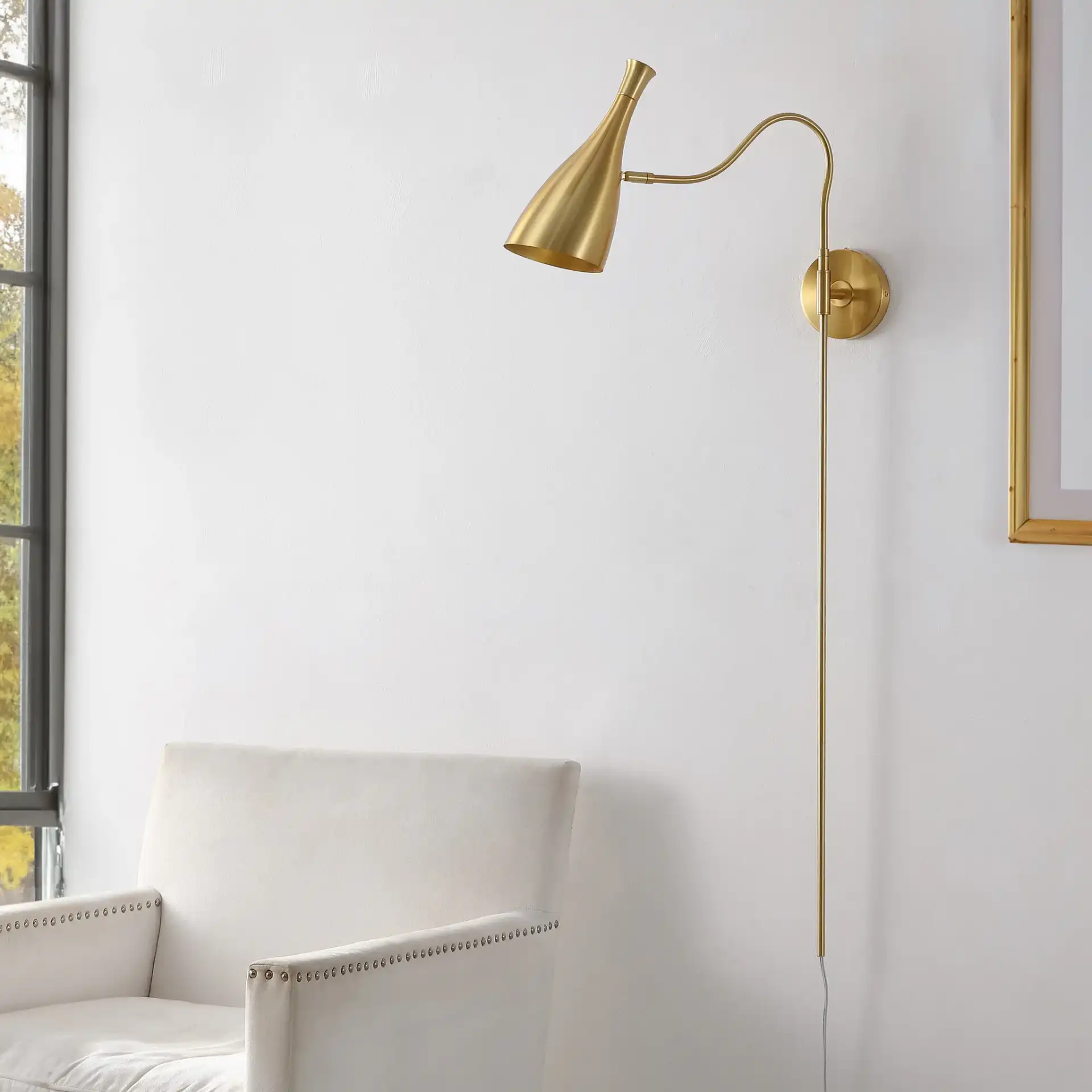 Hellene Wall Sconce in Brass in a styled room