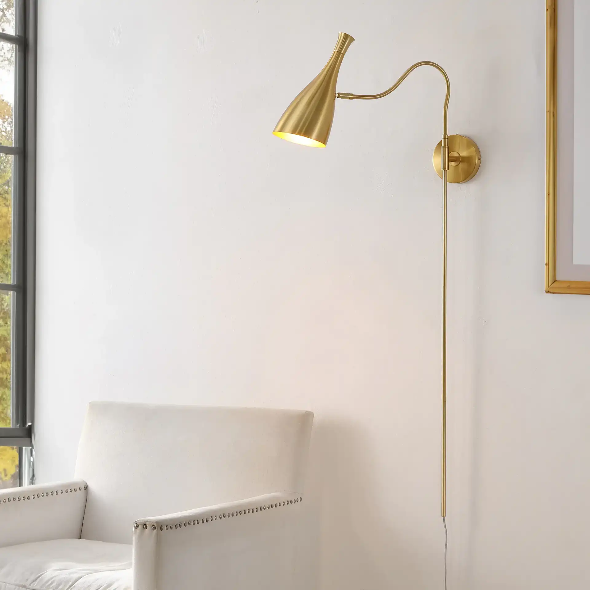 Hellene Wall Sconce in Brass in a styled room
