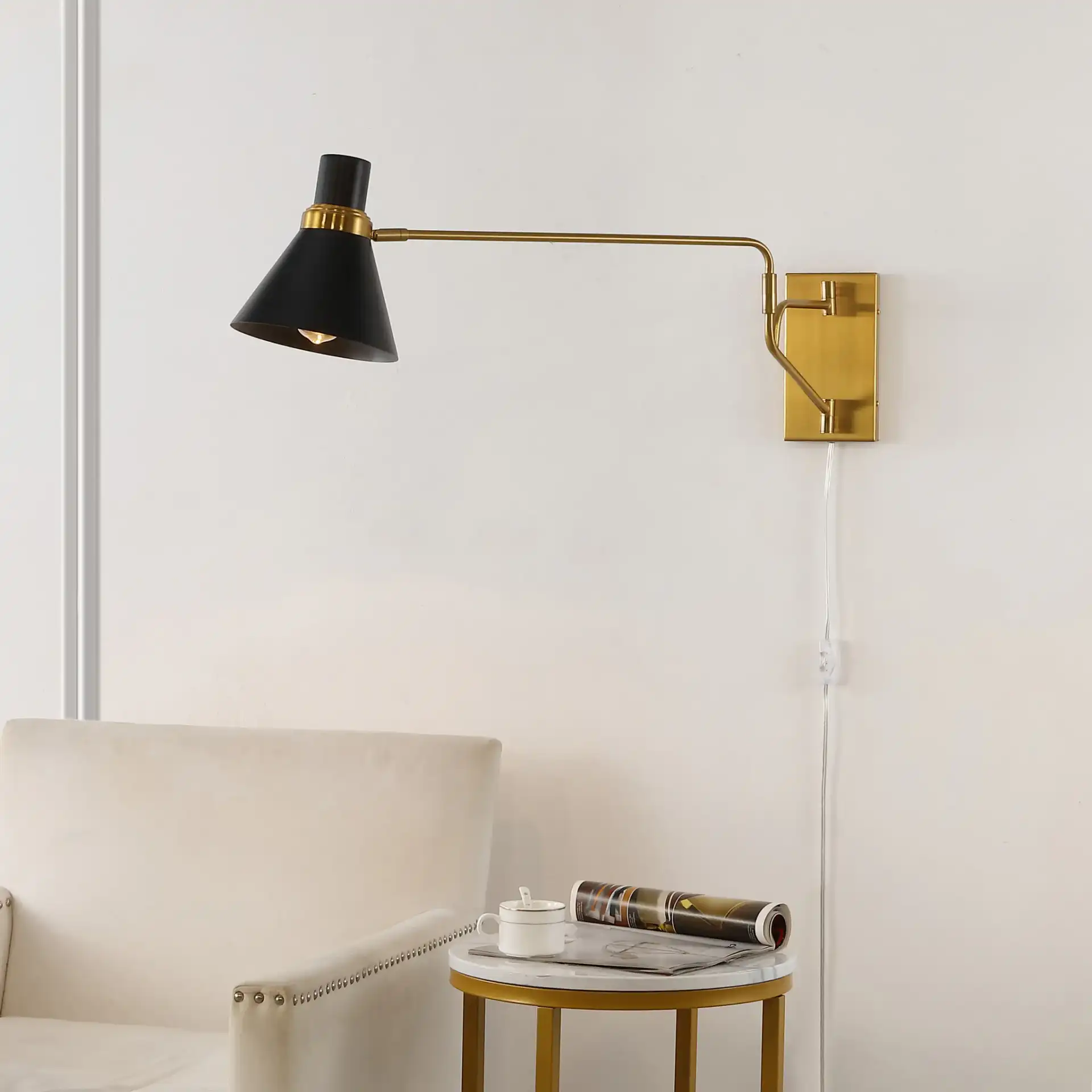 Cleome Wall Sconce in Brass / Black in a styled room